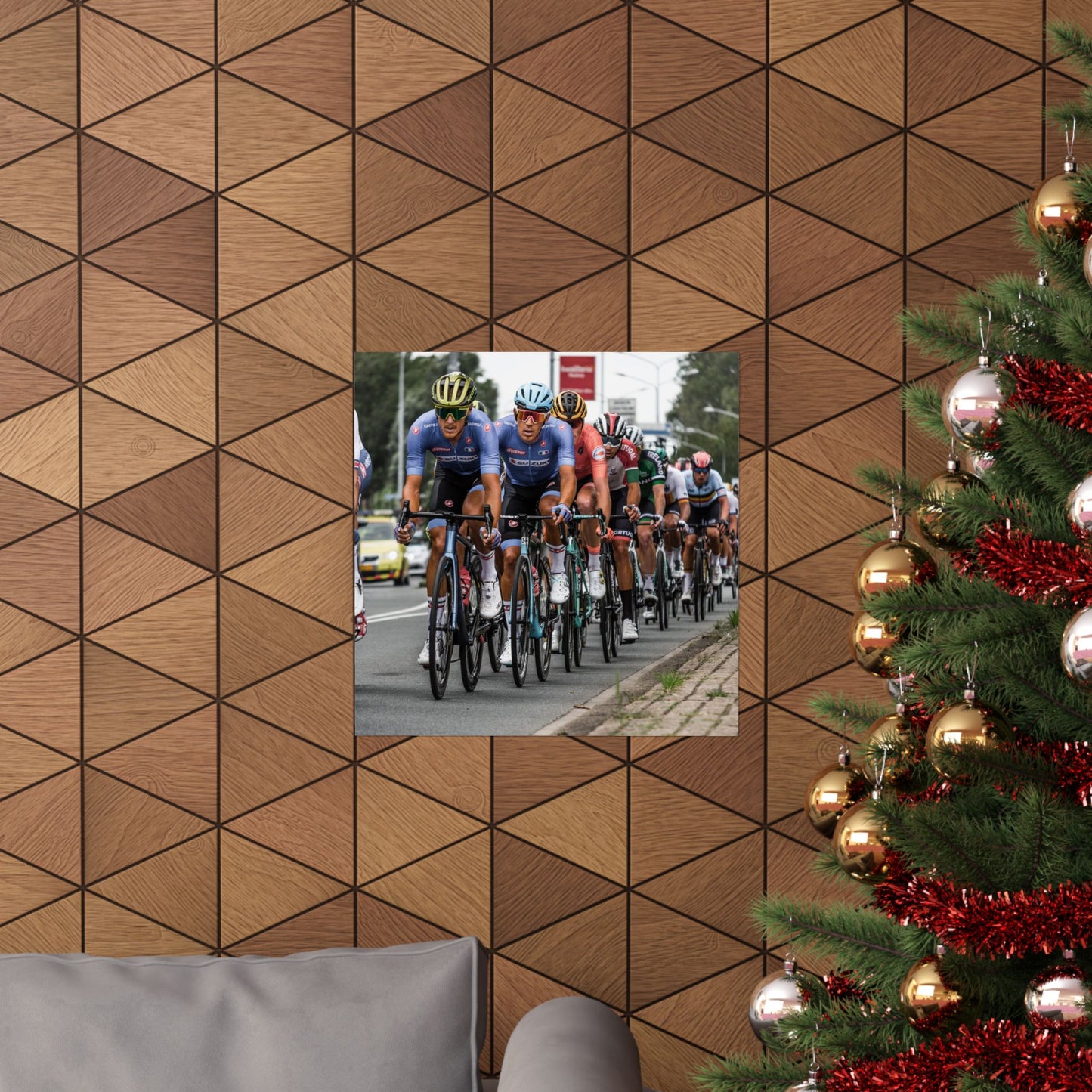 Wooden wall with geometric pattern, mirror reflecting a cycling race, and Christmas tree with decorations.