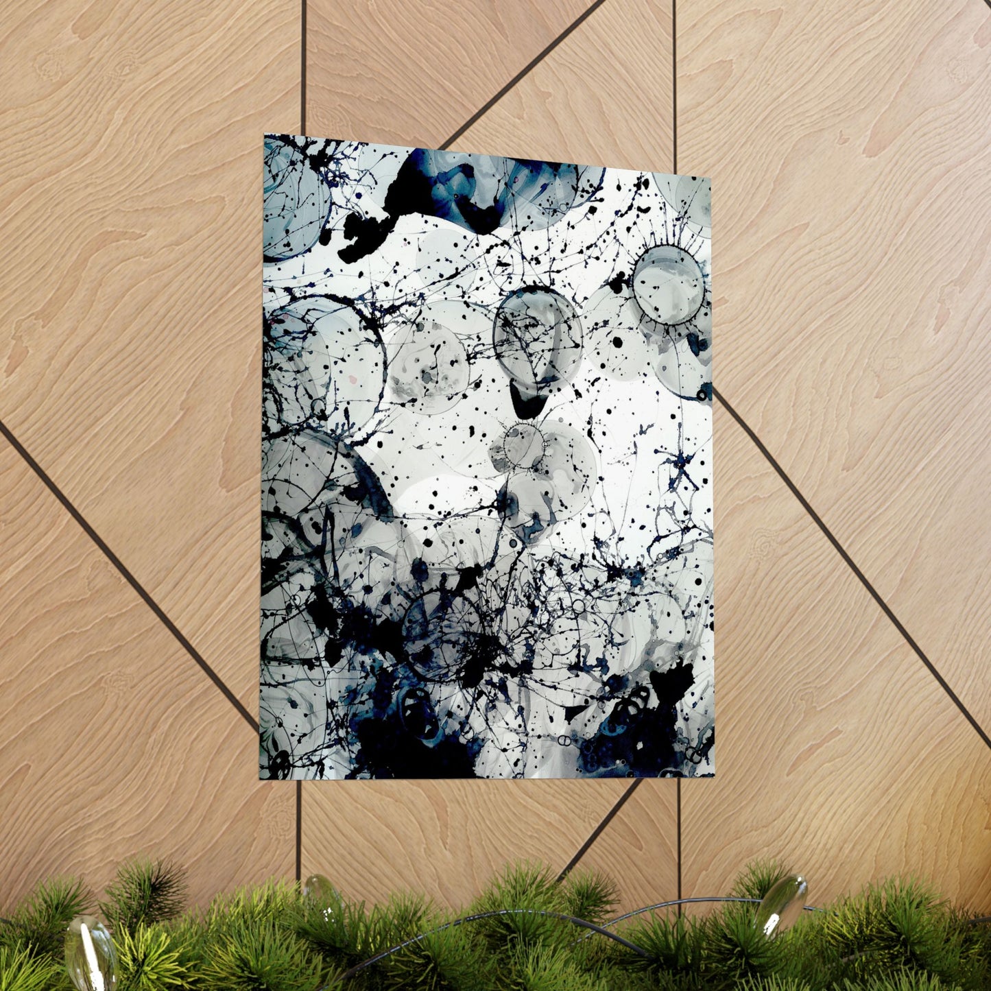 Abstract art print with black and white splashes on a wooden floor
