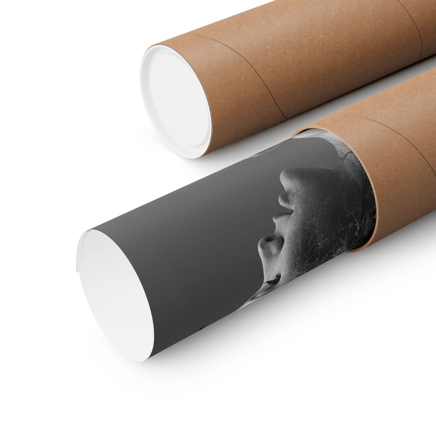 Two cylindrical paper rolls with one showing a black and white image of a face.