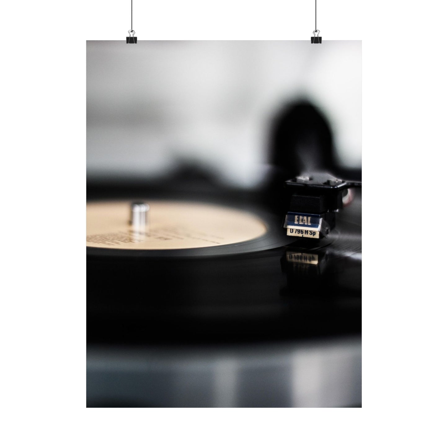 Vinyl record and turntable on a dark surface with a blurred background