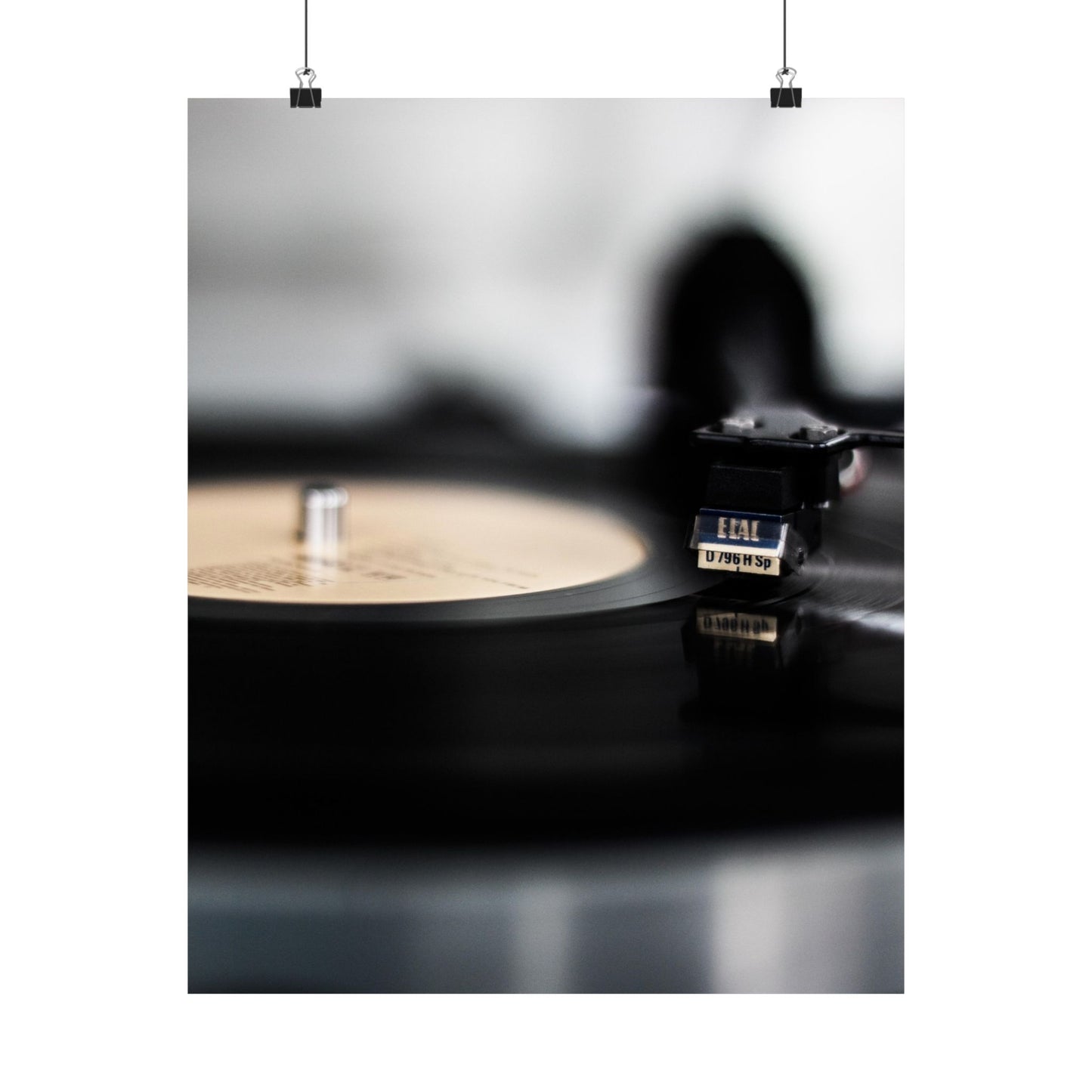 Vinyl record player with a vinyl record on a reflective surface