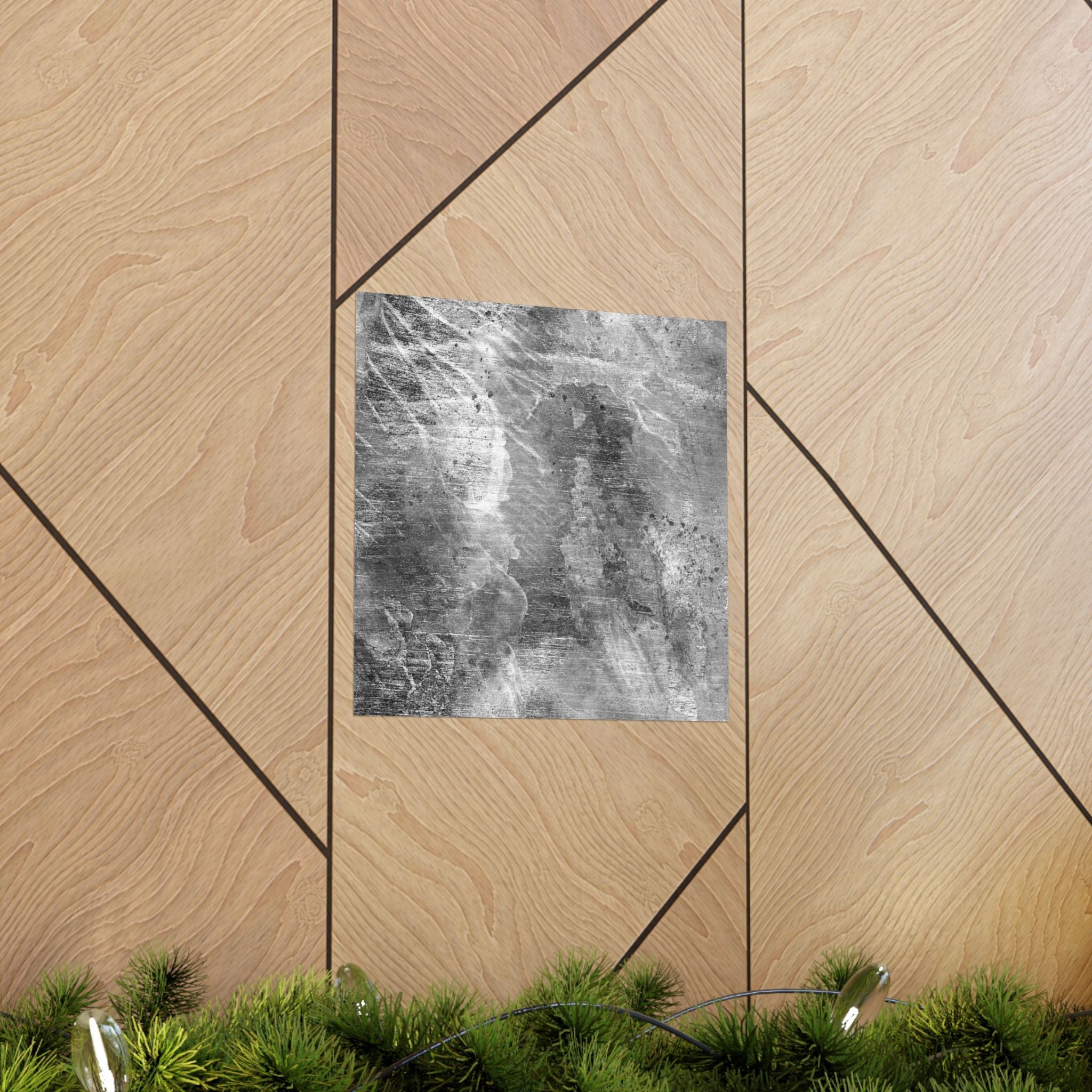 Decorative wall art on a geometric wooden panel with greenery at the bottom.