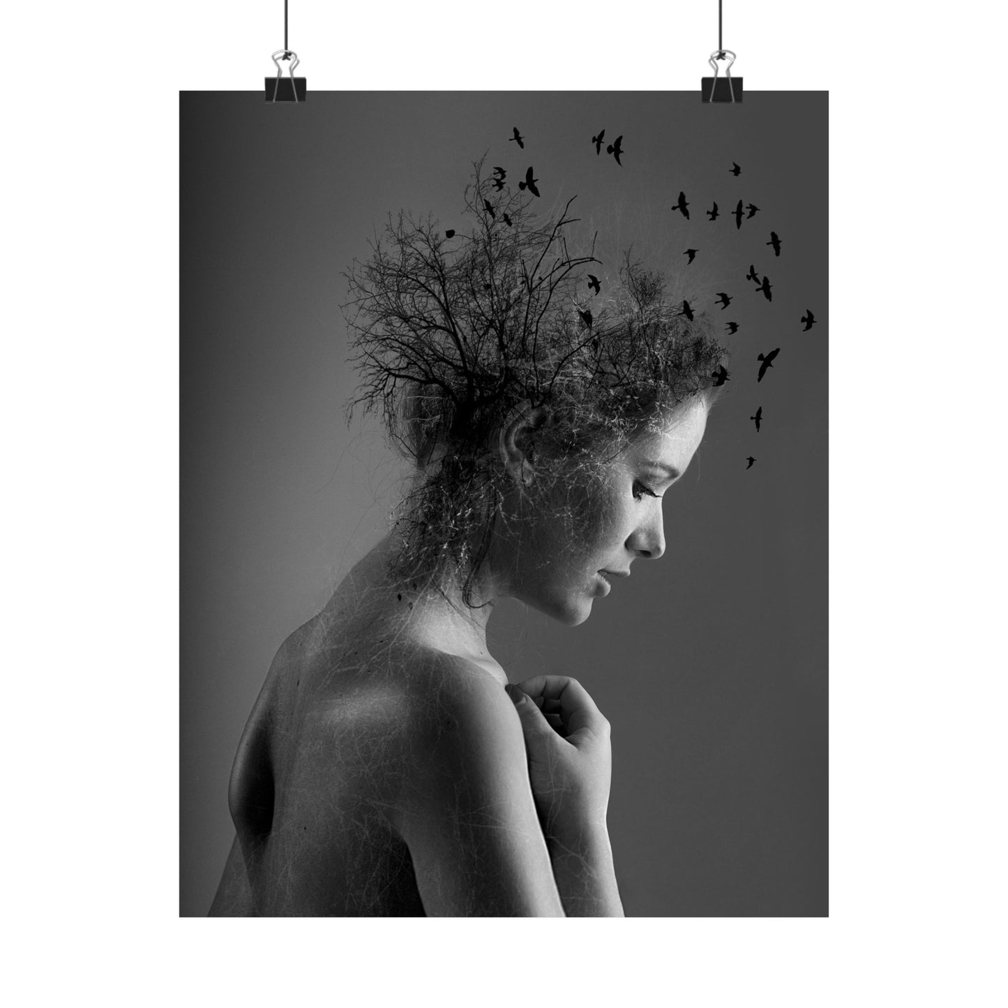 Black and white art print of a woman with birds in her hair on a dark background