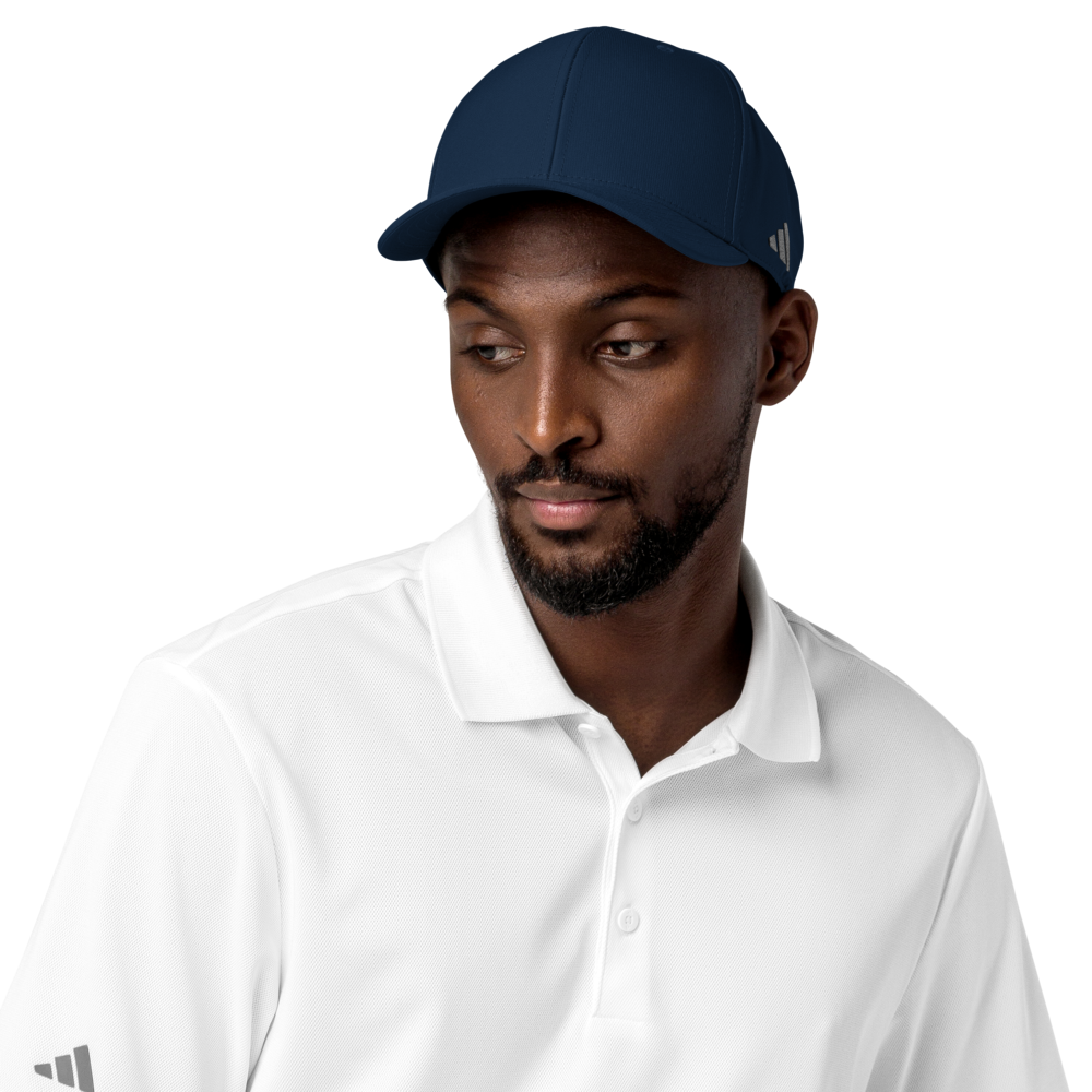 Man wearing a navy cap and white shirt with Adidas logo on a white background