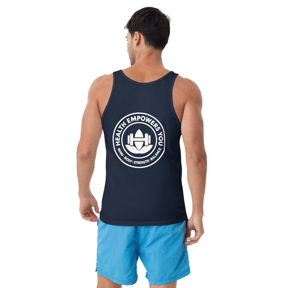 Man wearing a navy tank top with a white logo and blue shorts on a white background