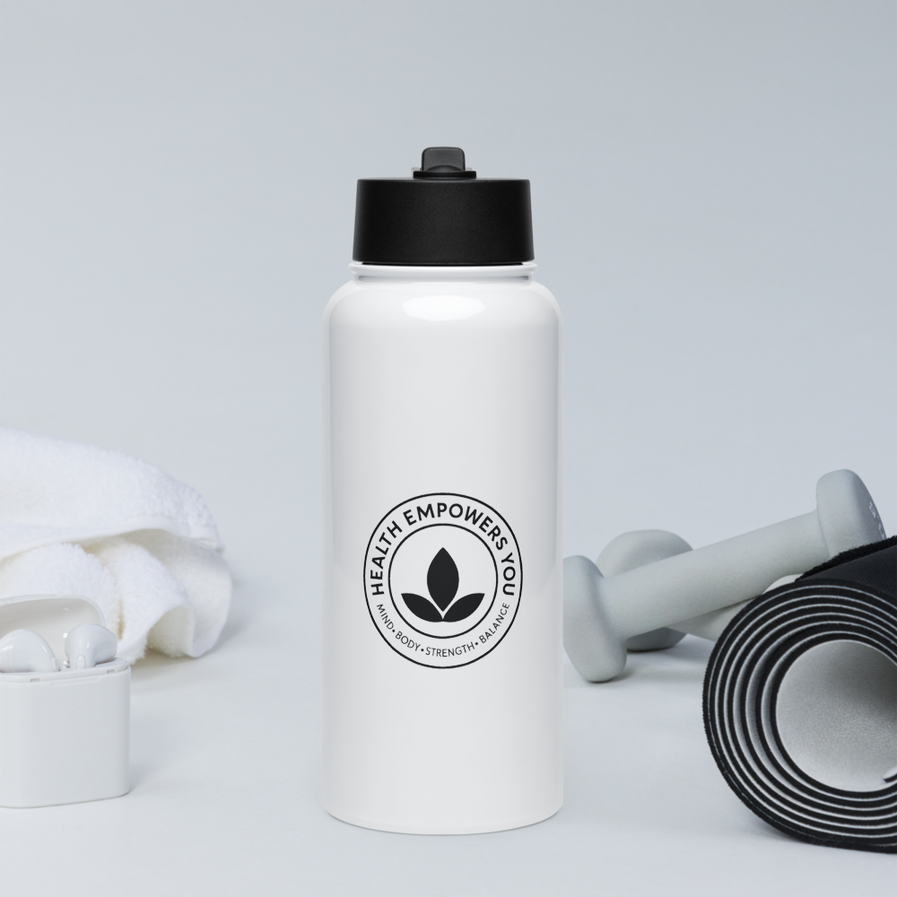 White water bottle with black lid and 'Health Empowers You' logo on a light gray background with fitness equipment.