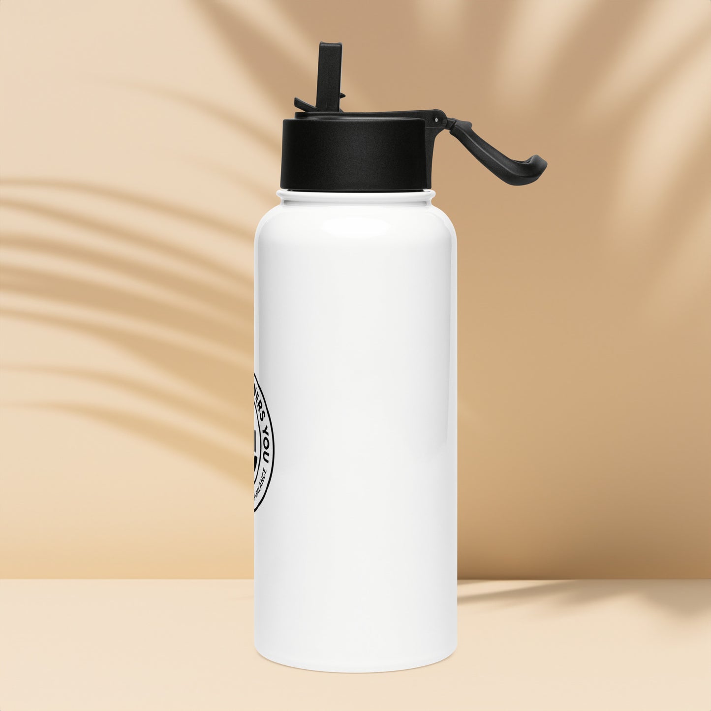 White water bottle with black cap on a beige background