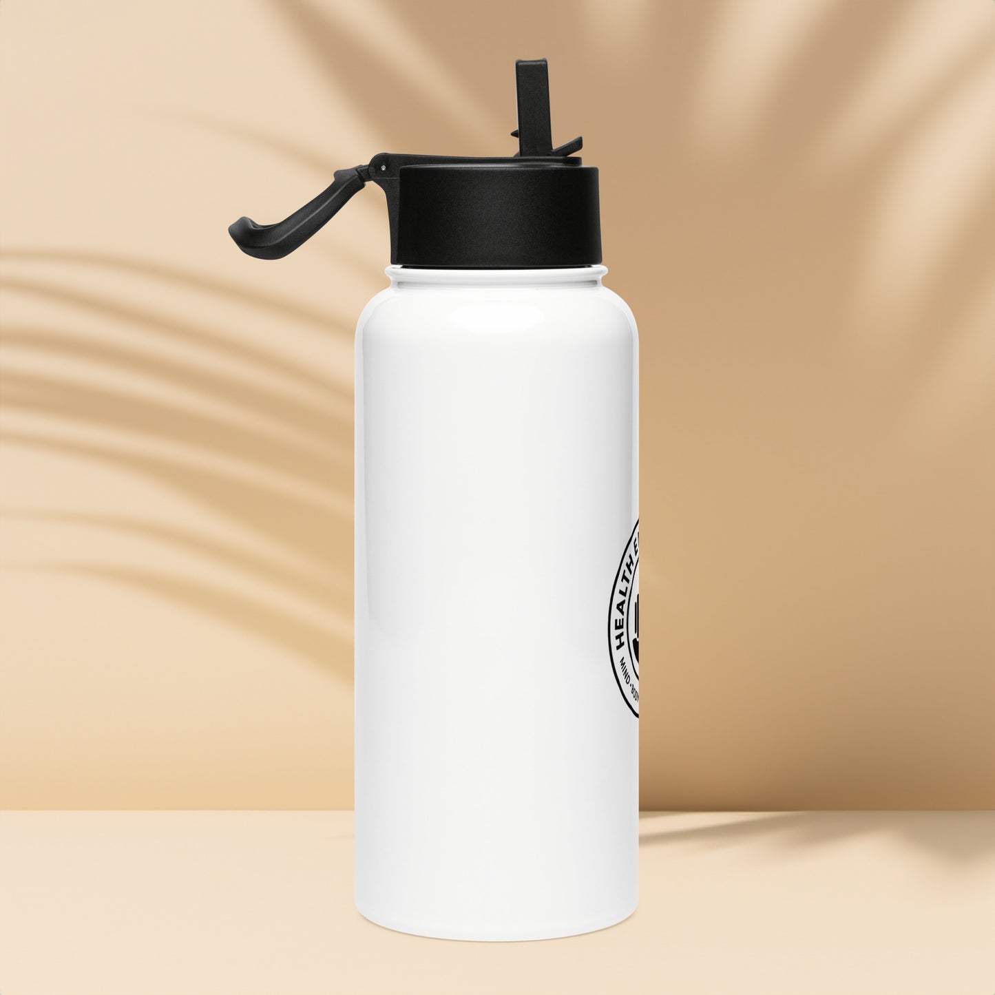White water bottle with black cap and logo on a beige background
