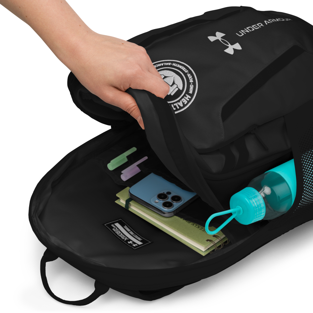 Black Under Armour backpack with items like a phone and water bottle inside, on a white background