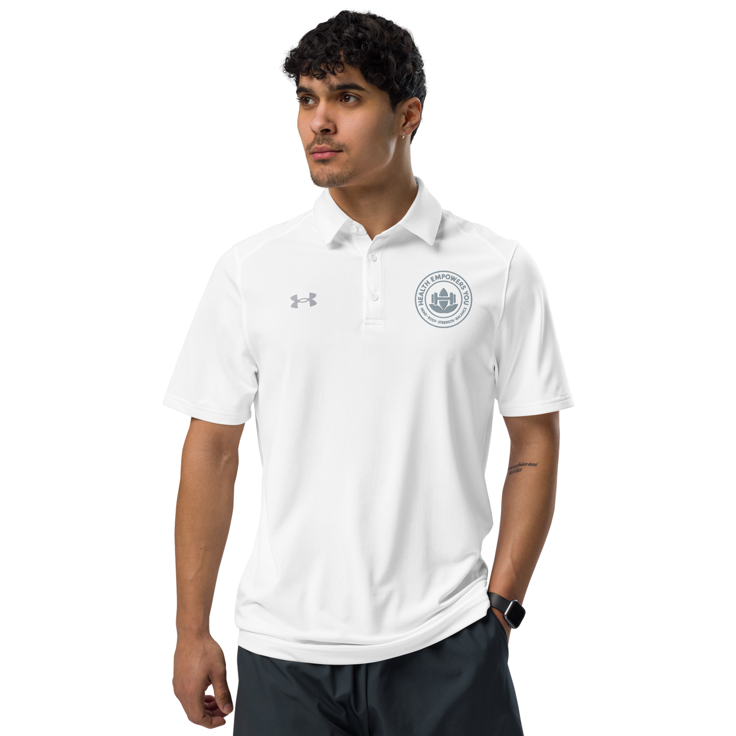 Man wearing a white polo shirt with a logo on a white background
