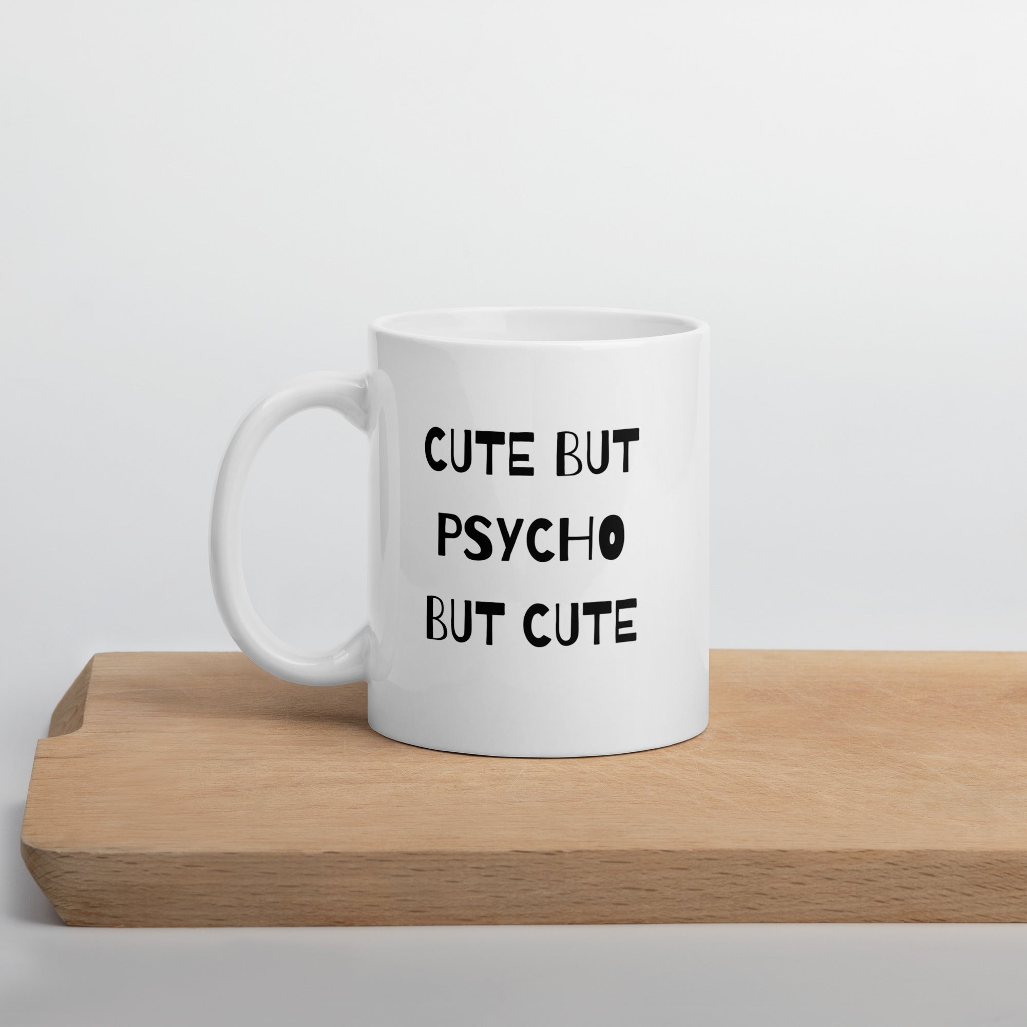 A white ceramic mug with the text &