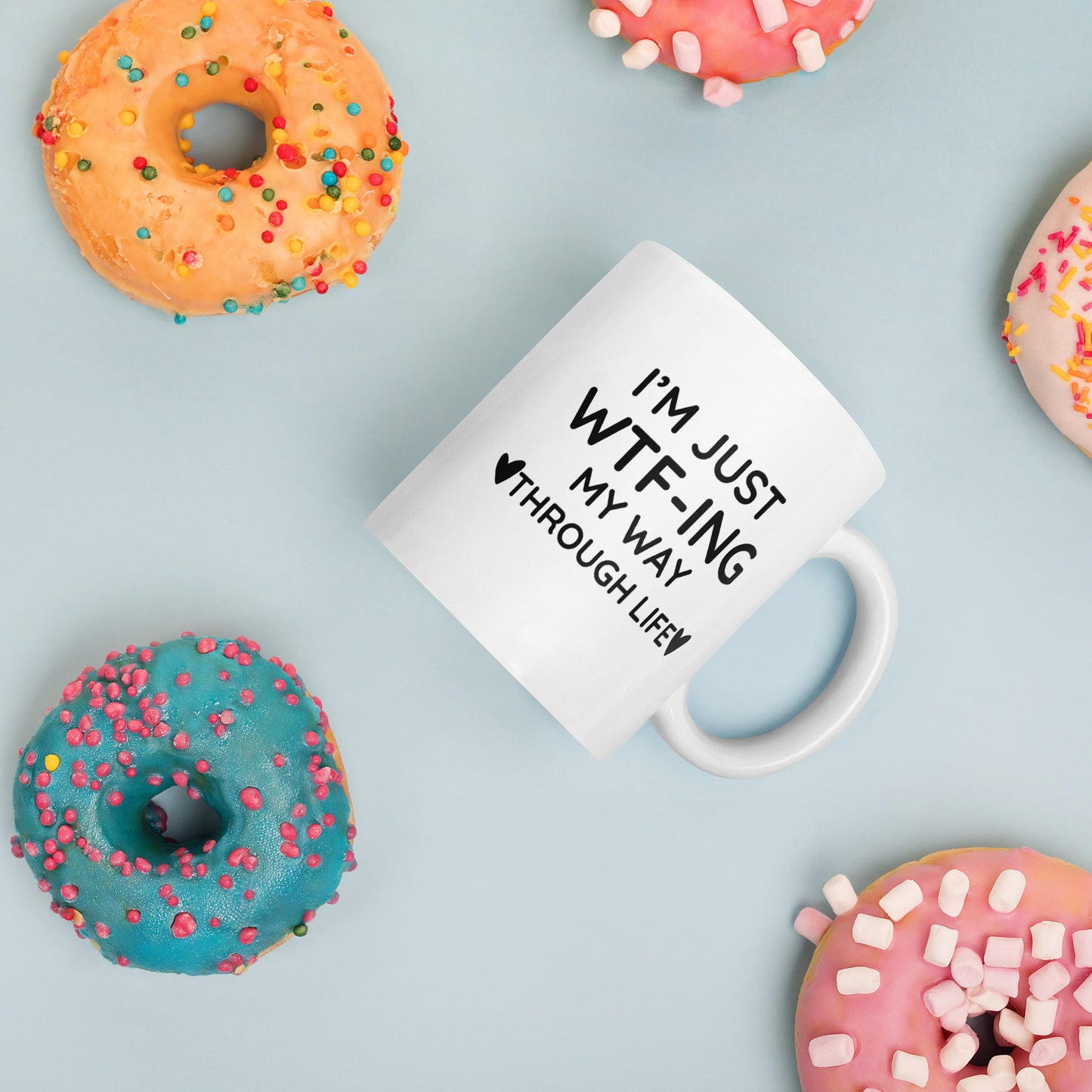 "White ceramic coffee mug with black text saying I'm Just WTF-ING My Way Through Life"