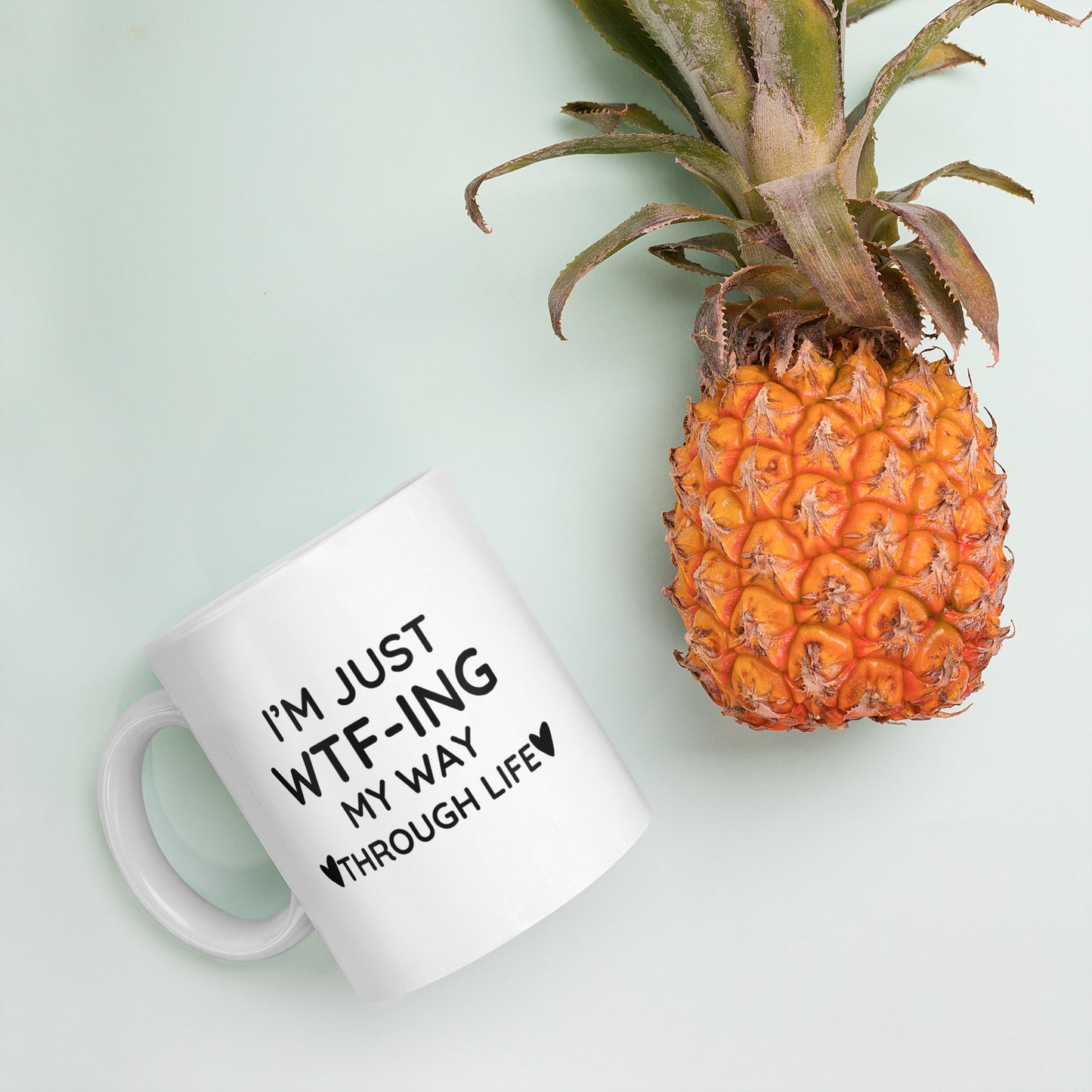 "White ceramic coffee mug with black text saying I'm Just WTF-ING My Way Through Life"