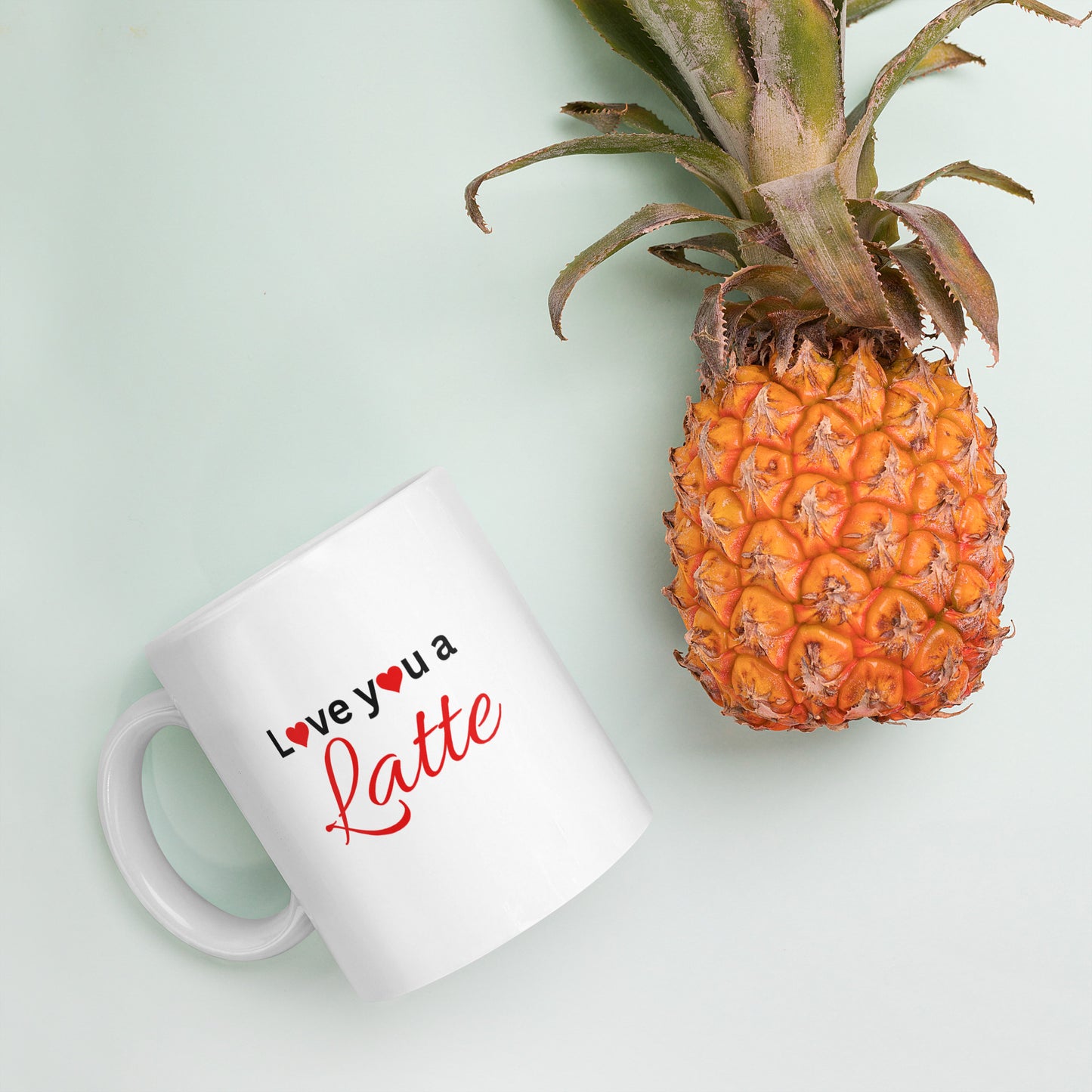 "White ceramic coffee mug with black text saying Love You a Latte with heart"