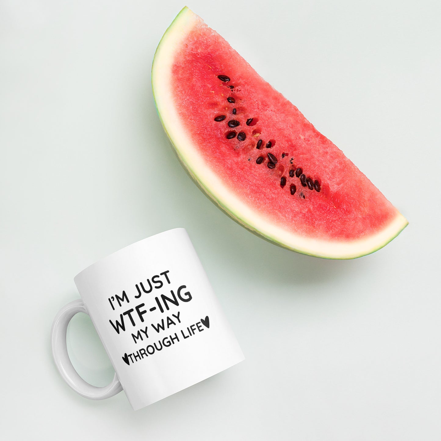 "White ceramic coffee mug with black text saying I'm Just WTF-ING My Way Through Life"