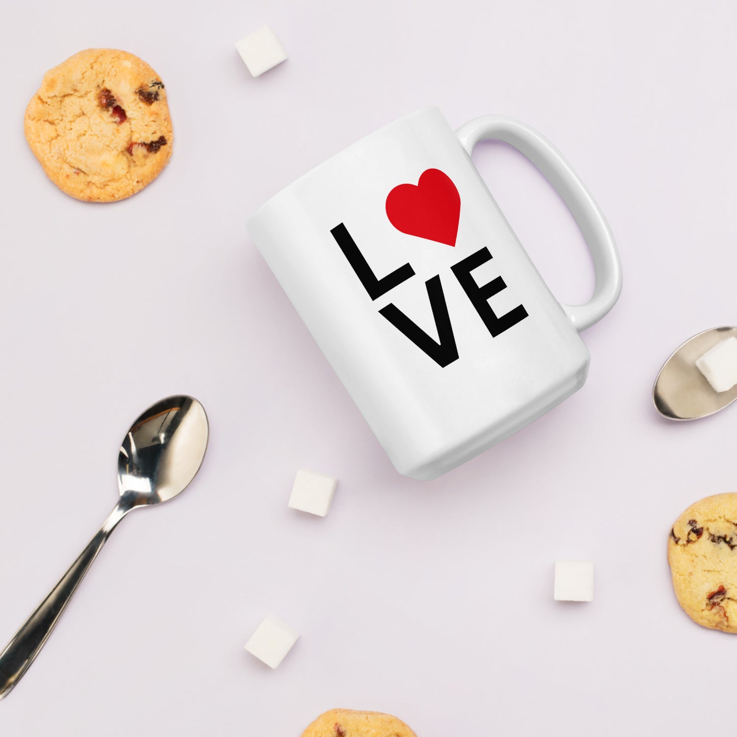 "White ceramic coffee mug with black text saying Love with red heart symbol"