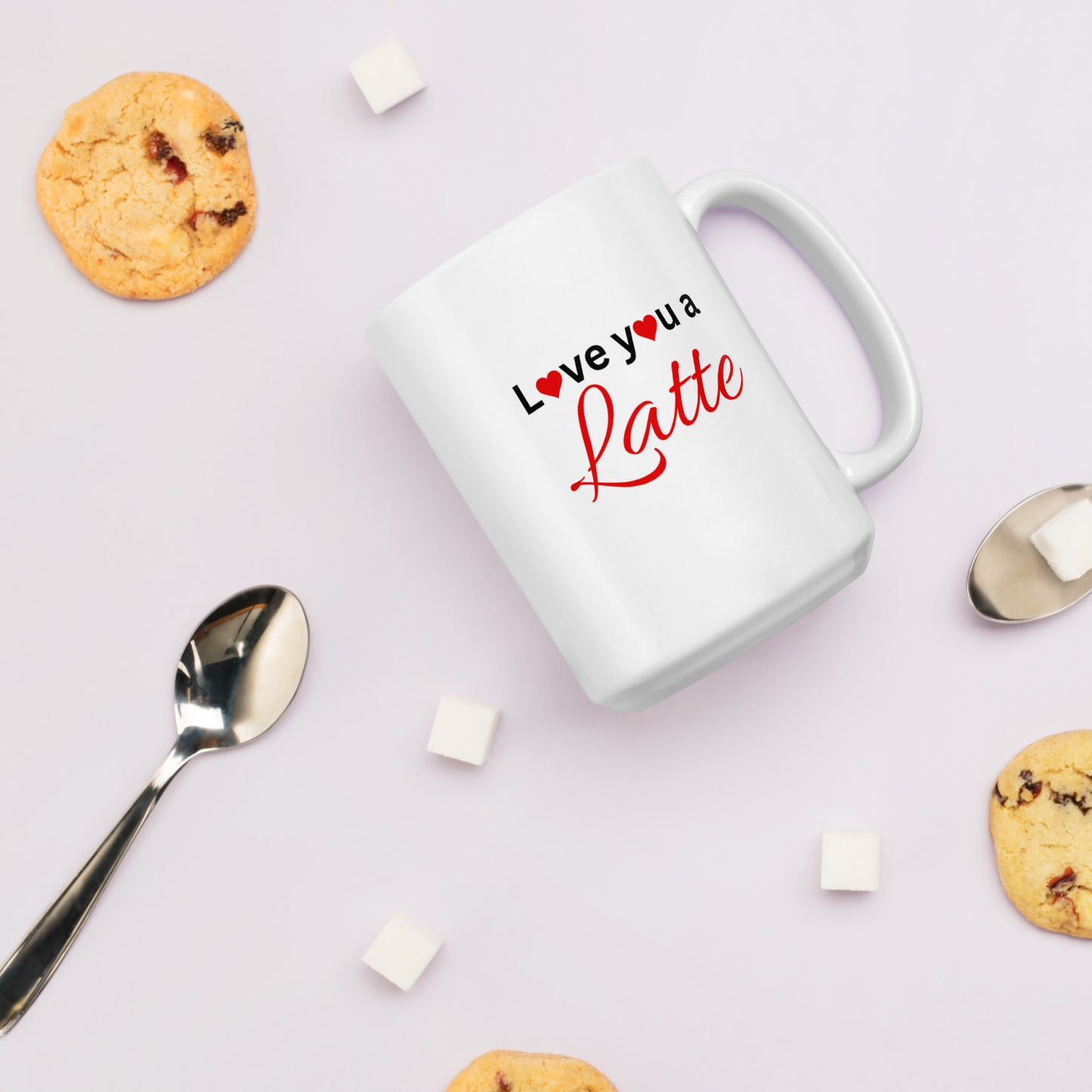 "White ceramic coffee mug with black text saying Love You a Latte with heart"