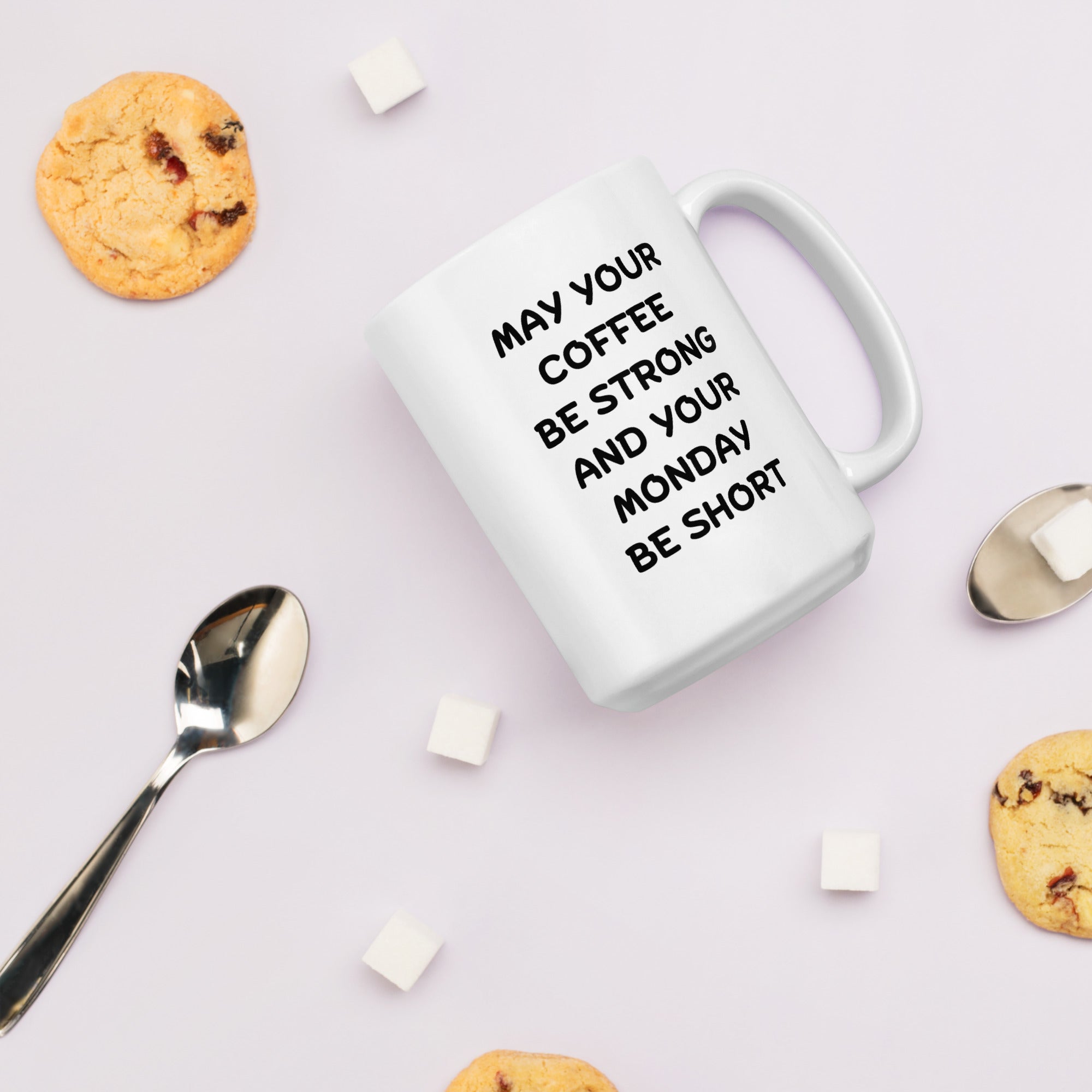 A white ceramic coffee mug with black text reading &