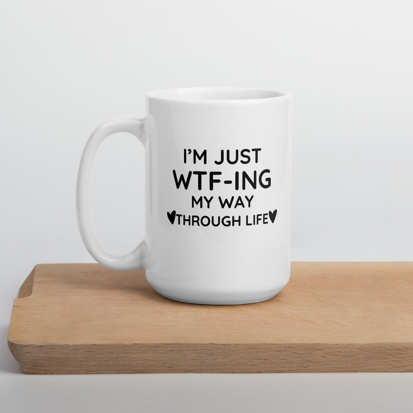 "White ceramic coffee mug with black text saying I'm Just WTF-ING My Way Through Life"