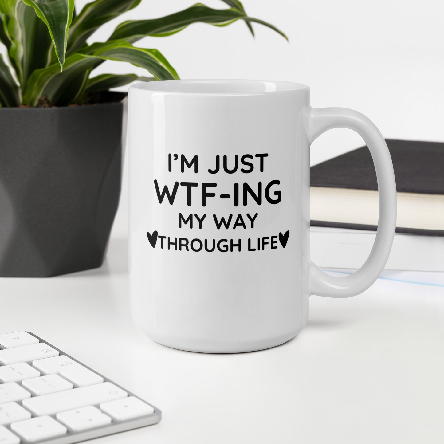 "White ceramic coffee mug with black text saying I'm Just WTF-ING My Way Through Life"