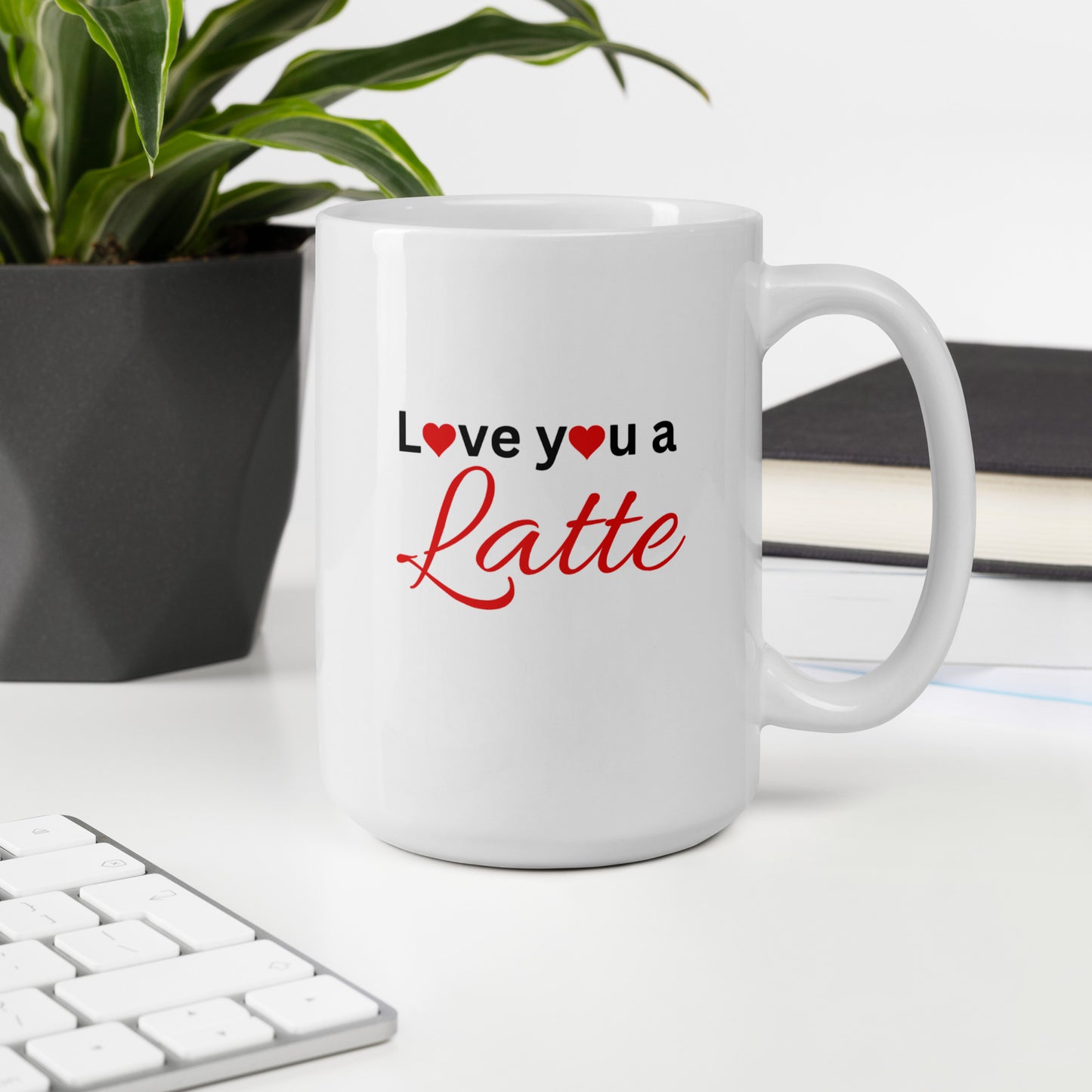 "White ceramic coffee mug with black text saying Love You a Latte with heart"