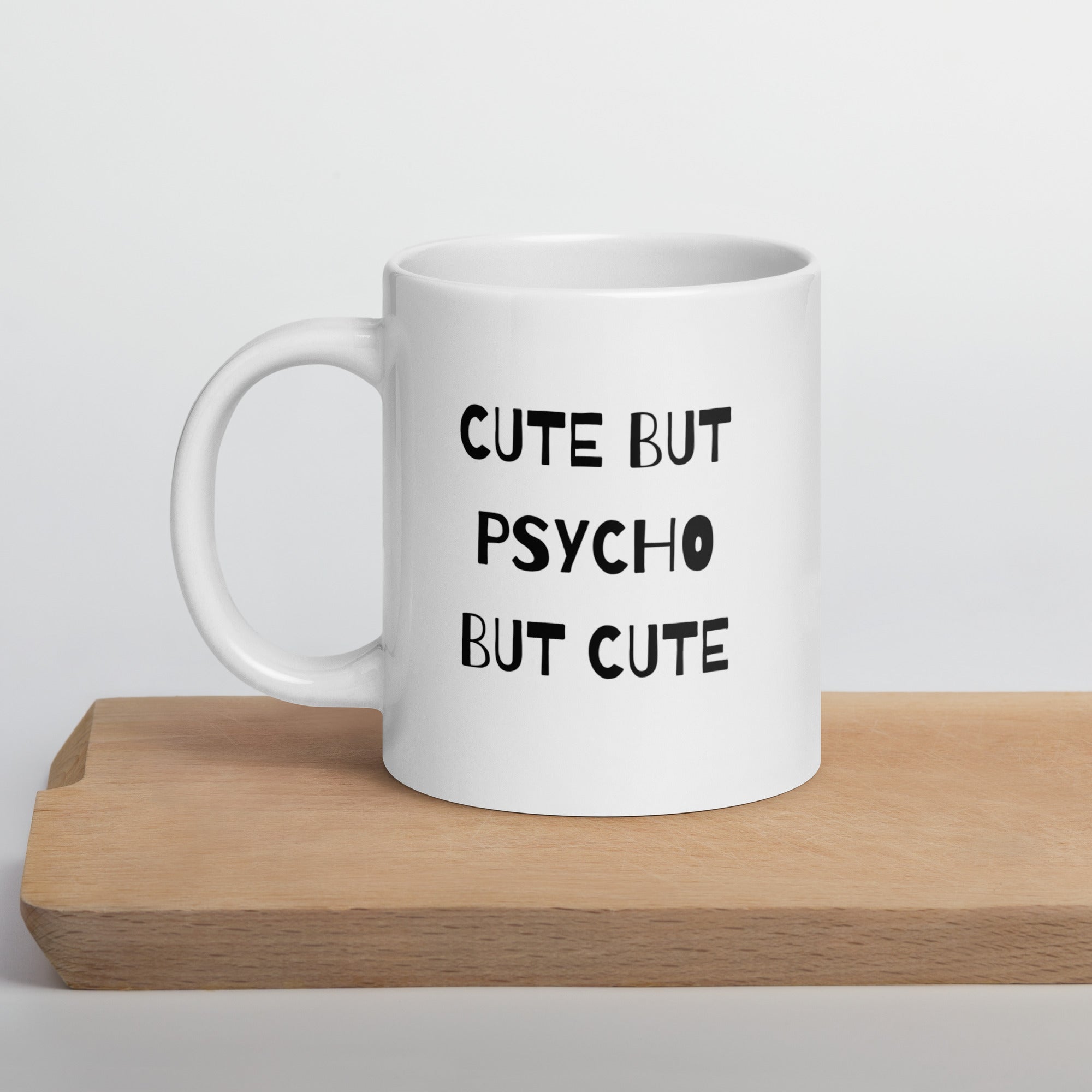 A white ceramic mug with the text &