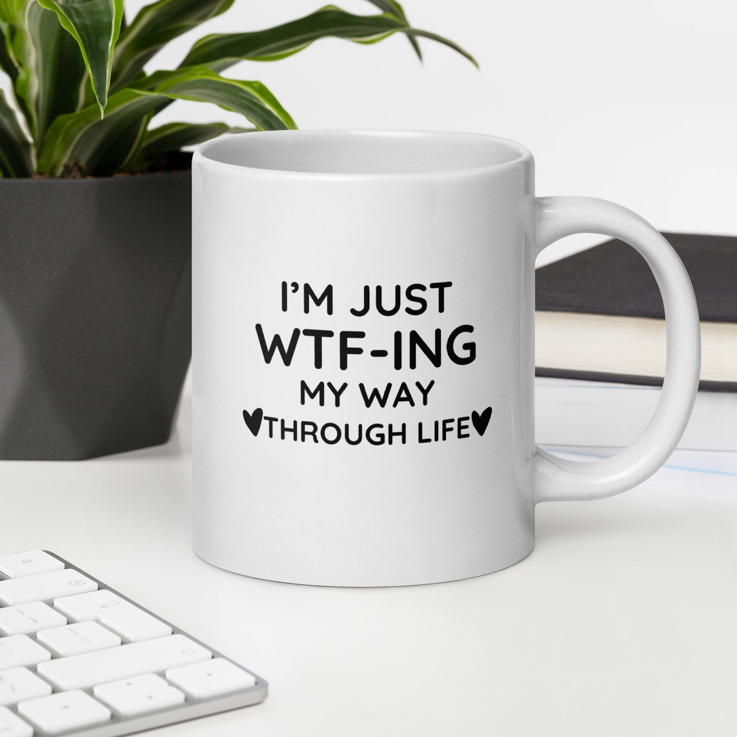 "White ceramic coffee mug with black text saying I'm Just WTF-ING My Way Through Life"