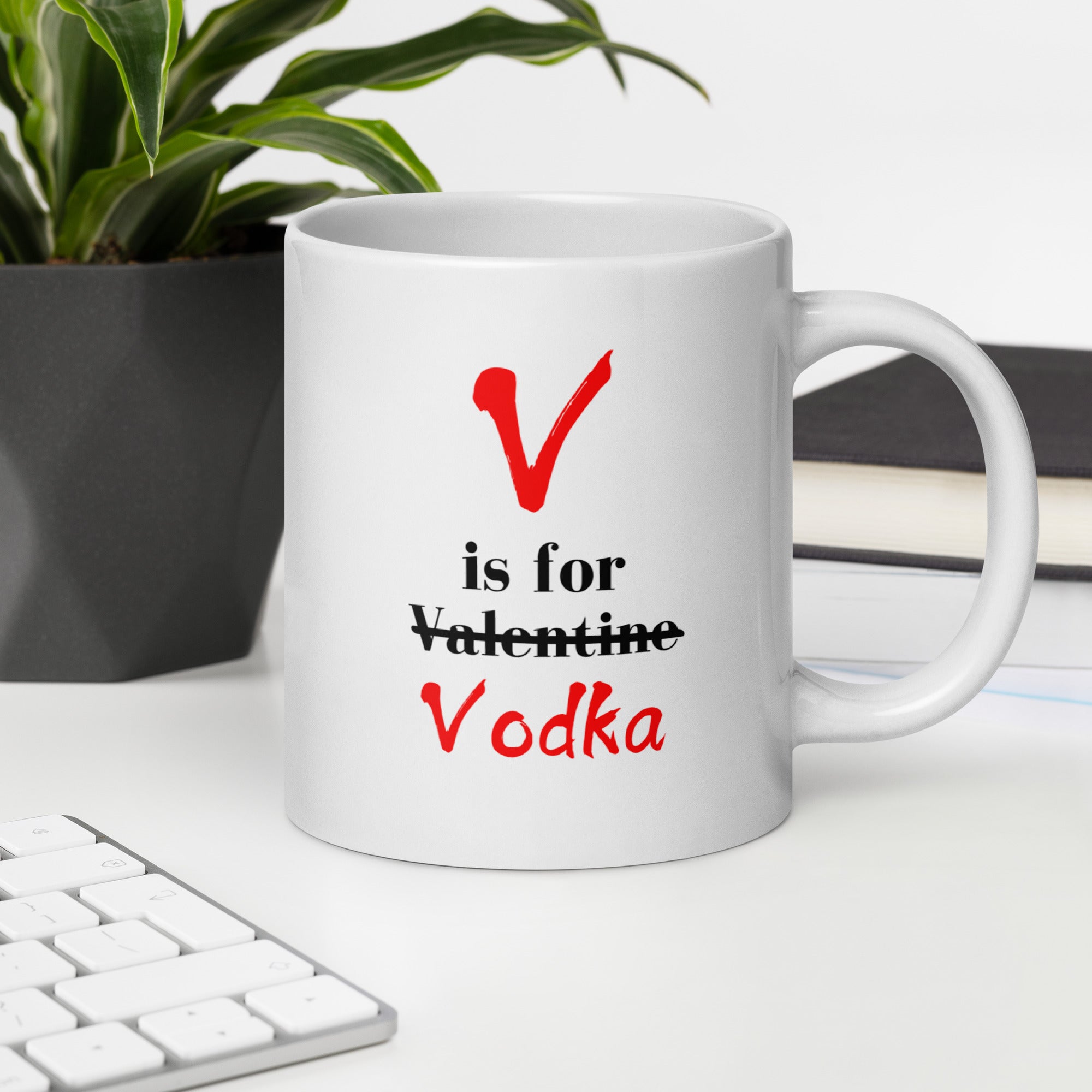 "White ceramic coffee mug with black text saying V Is For Valentine crossed out Vodka"