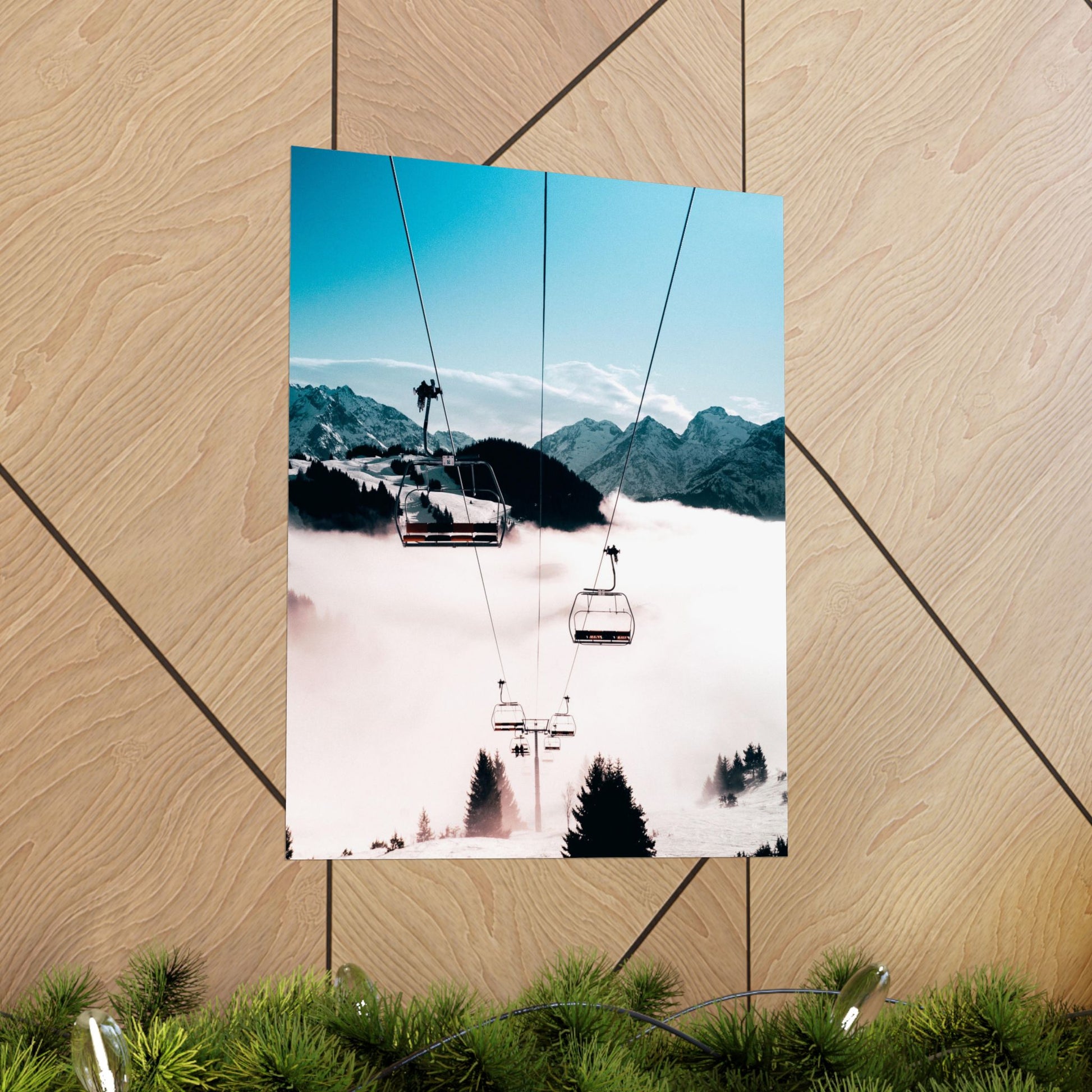 Poster of a snowy mountain landscape with a ski lift on a wooden surface.