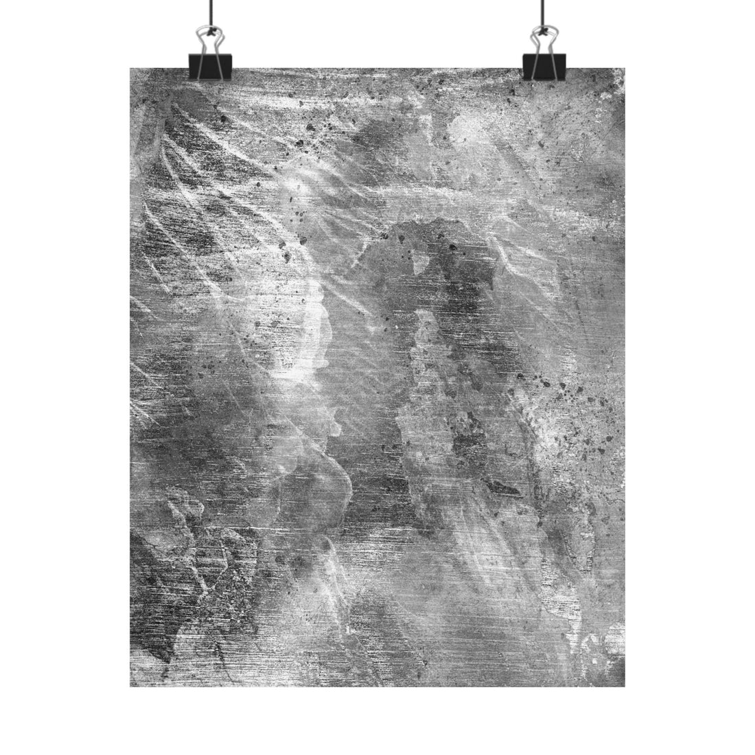 Abstract black and white artwork on a textured surface with two clips holding it up.