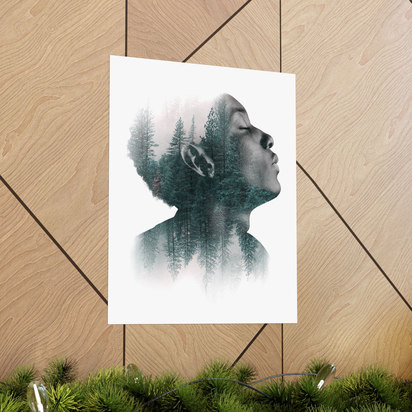 Poster with a double exposure of a person's profile and forest on a wooden floor.