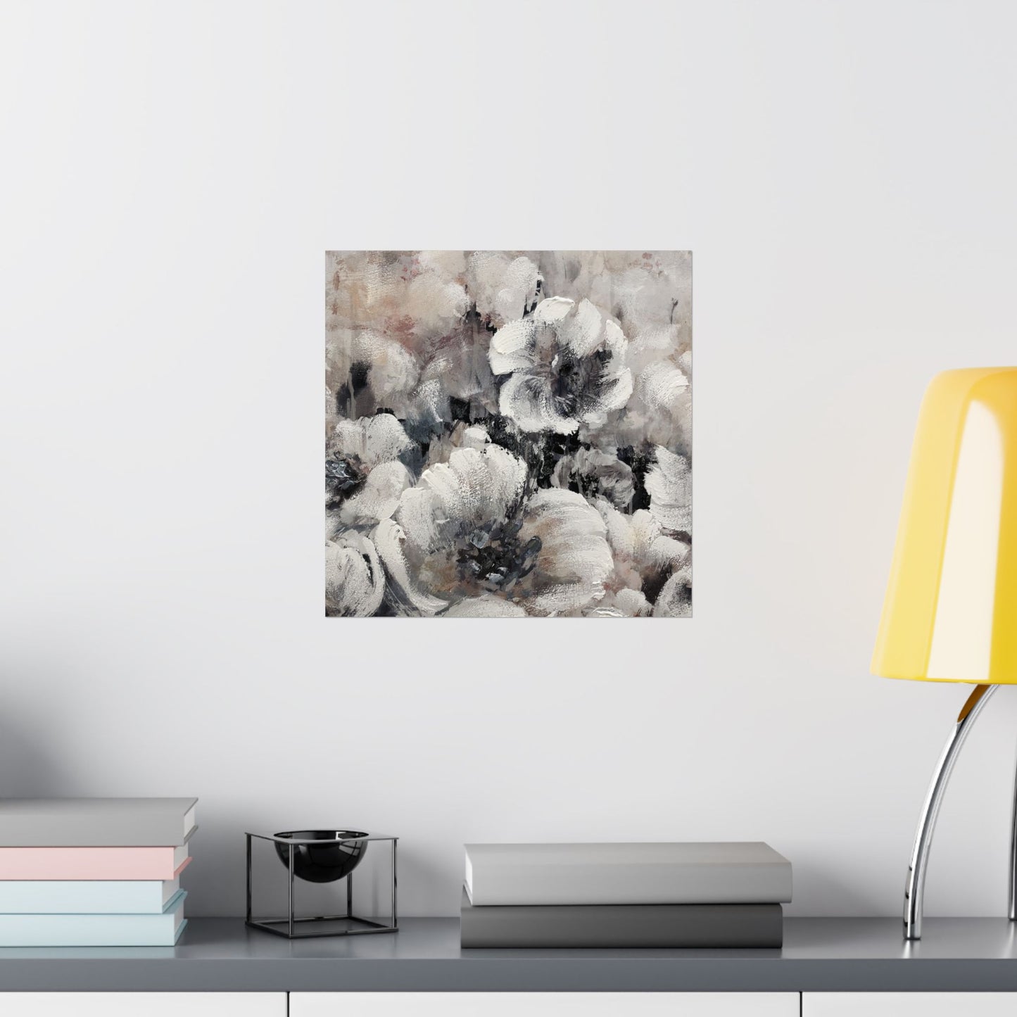 Abstract floral painting on a wall above a shelf with books and decor items.
