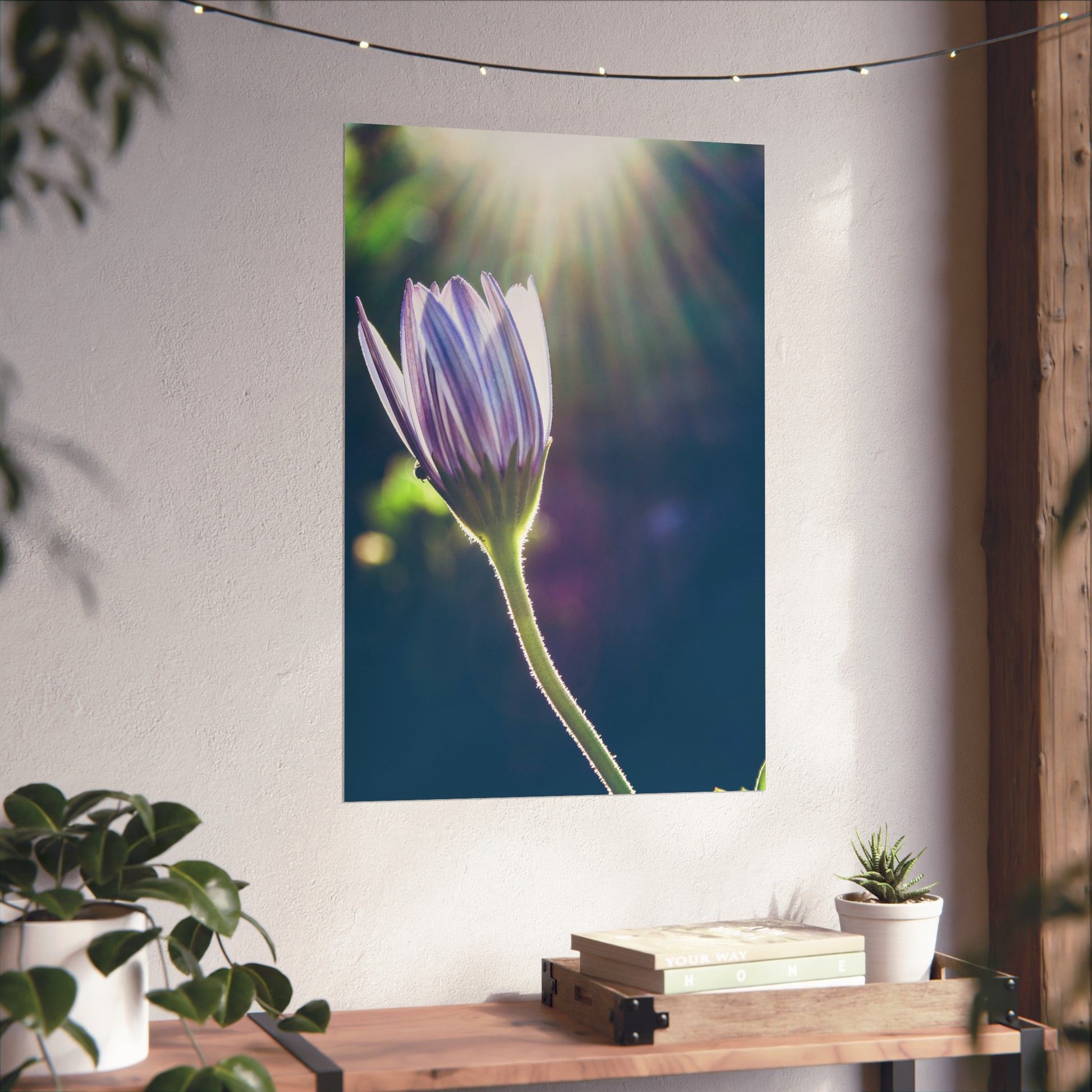 Floral tapestry hanging on a wall with a table and plants below