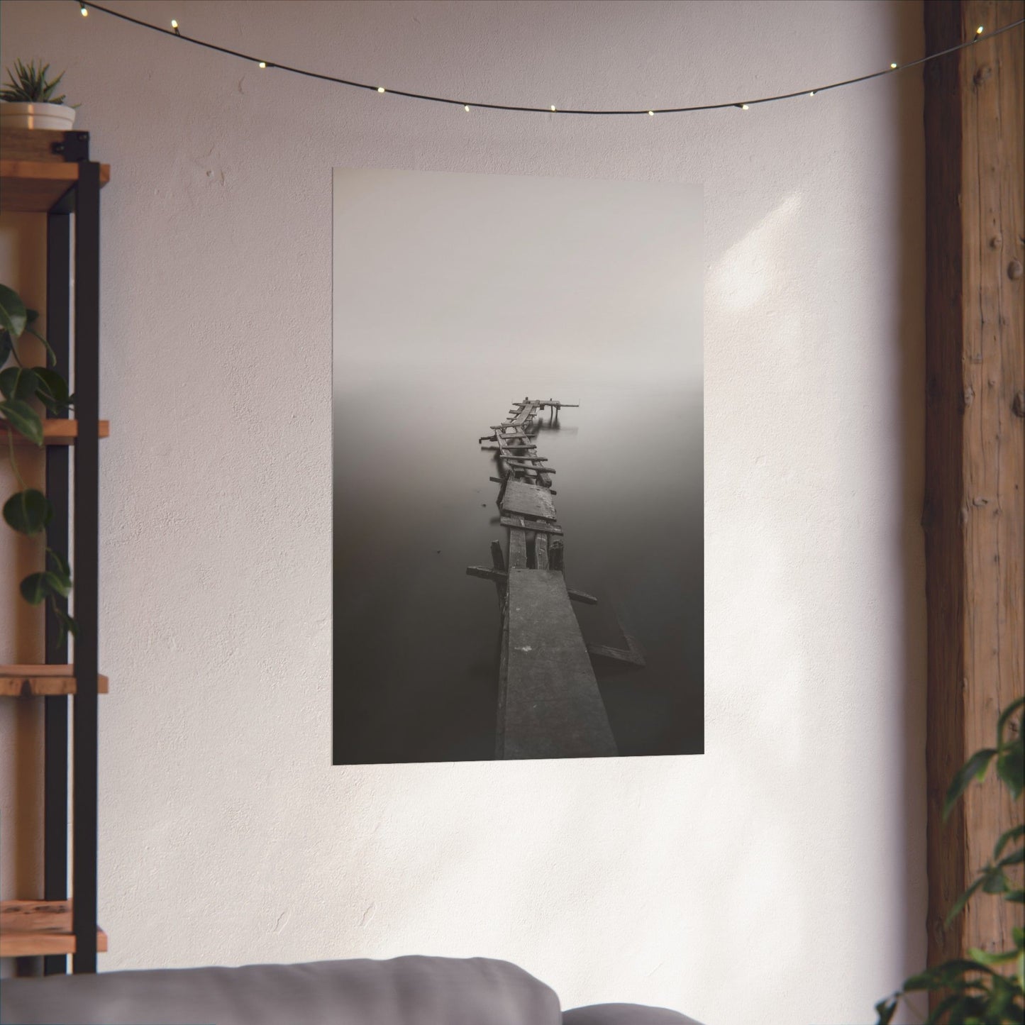 Poster of a dock on a wall in a room with a shelf and plants.