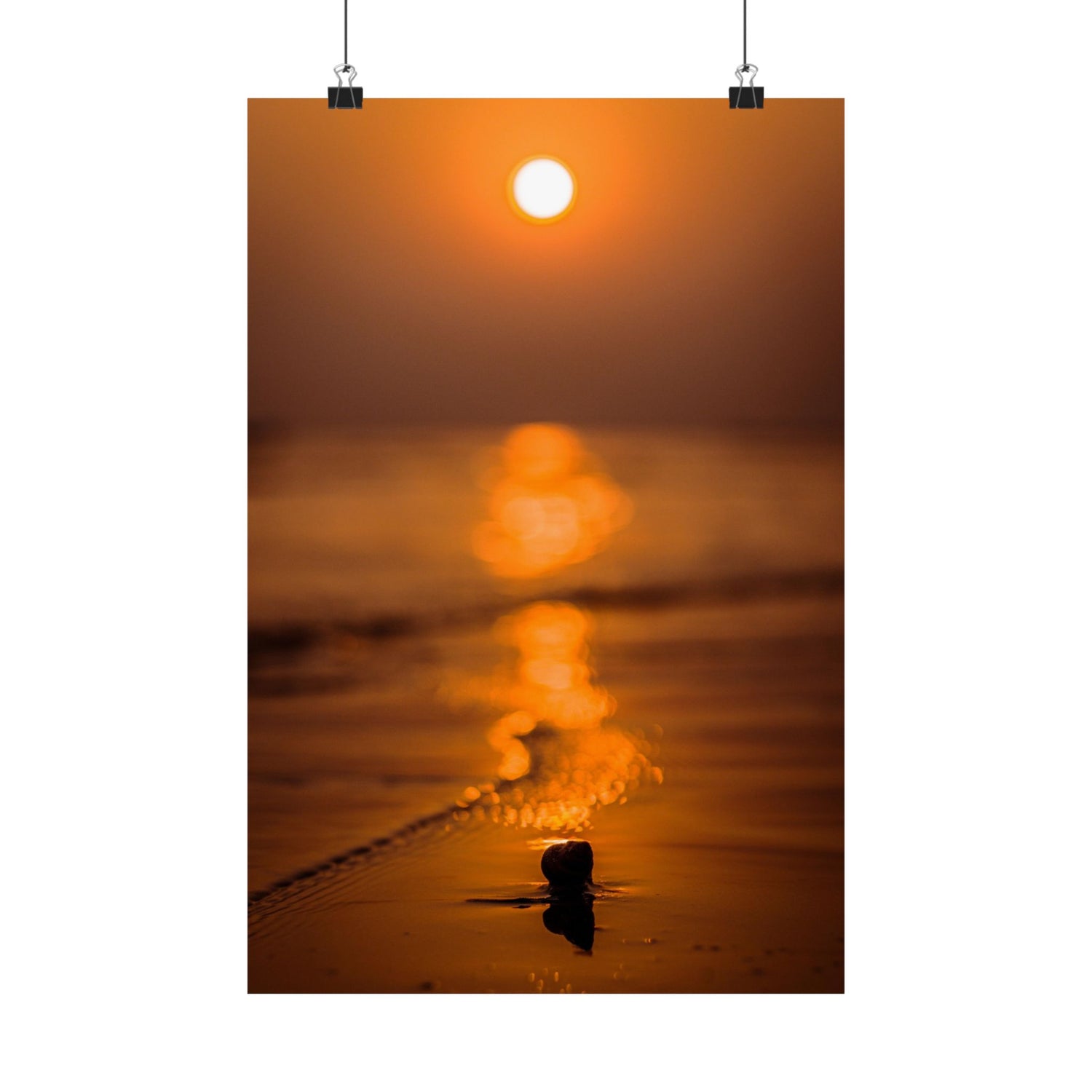 Sunset over water with a small object in the foreground