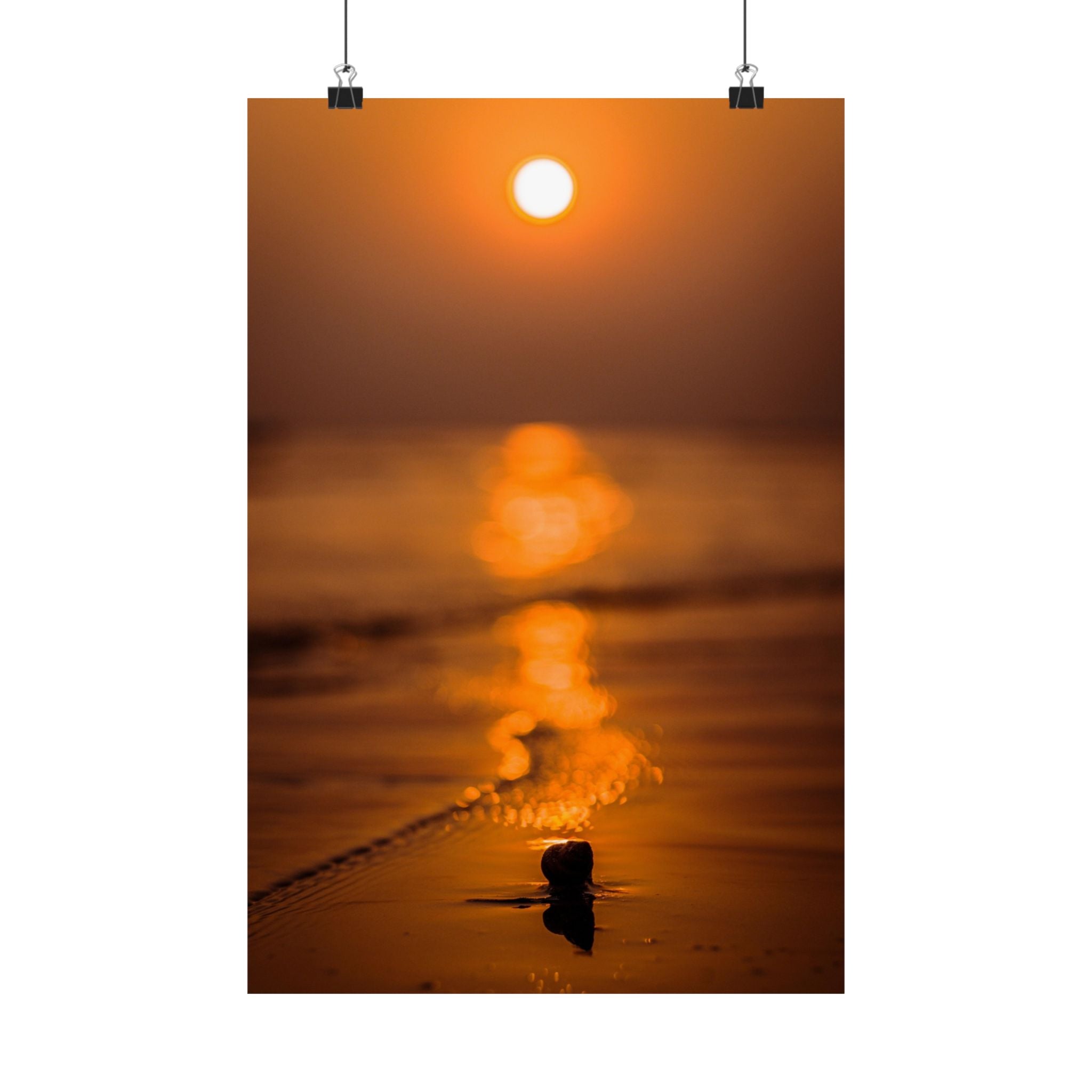 Sunset over water with a small object in the foreground