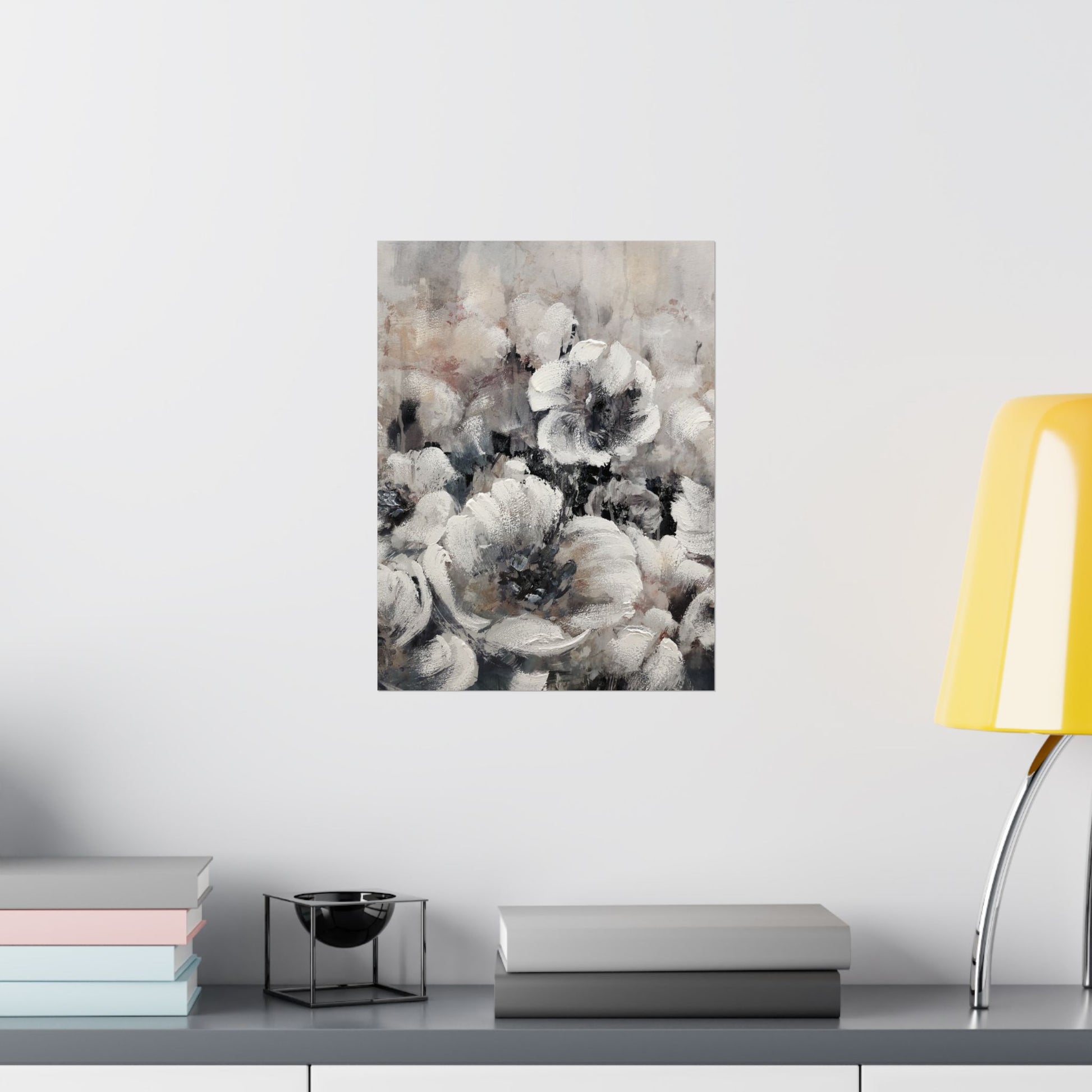 Floral painting on a wall above a shelf with books and a lamp.