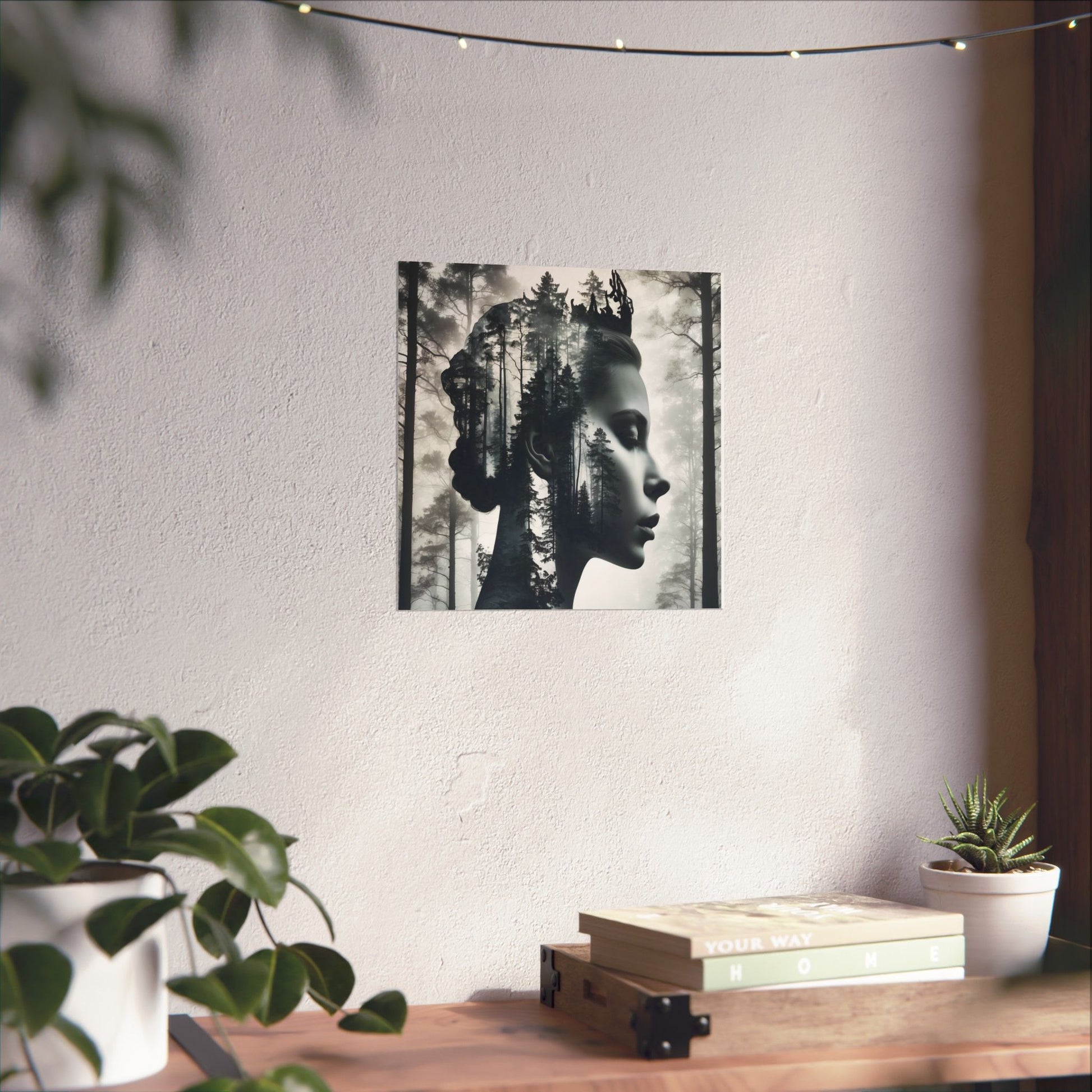 Poster of a woman with nature elements on a wall above a wooden desk with plants and books.