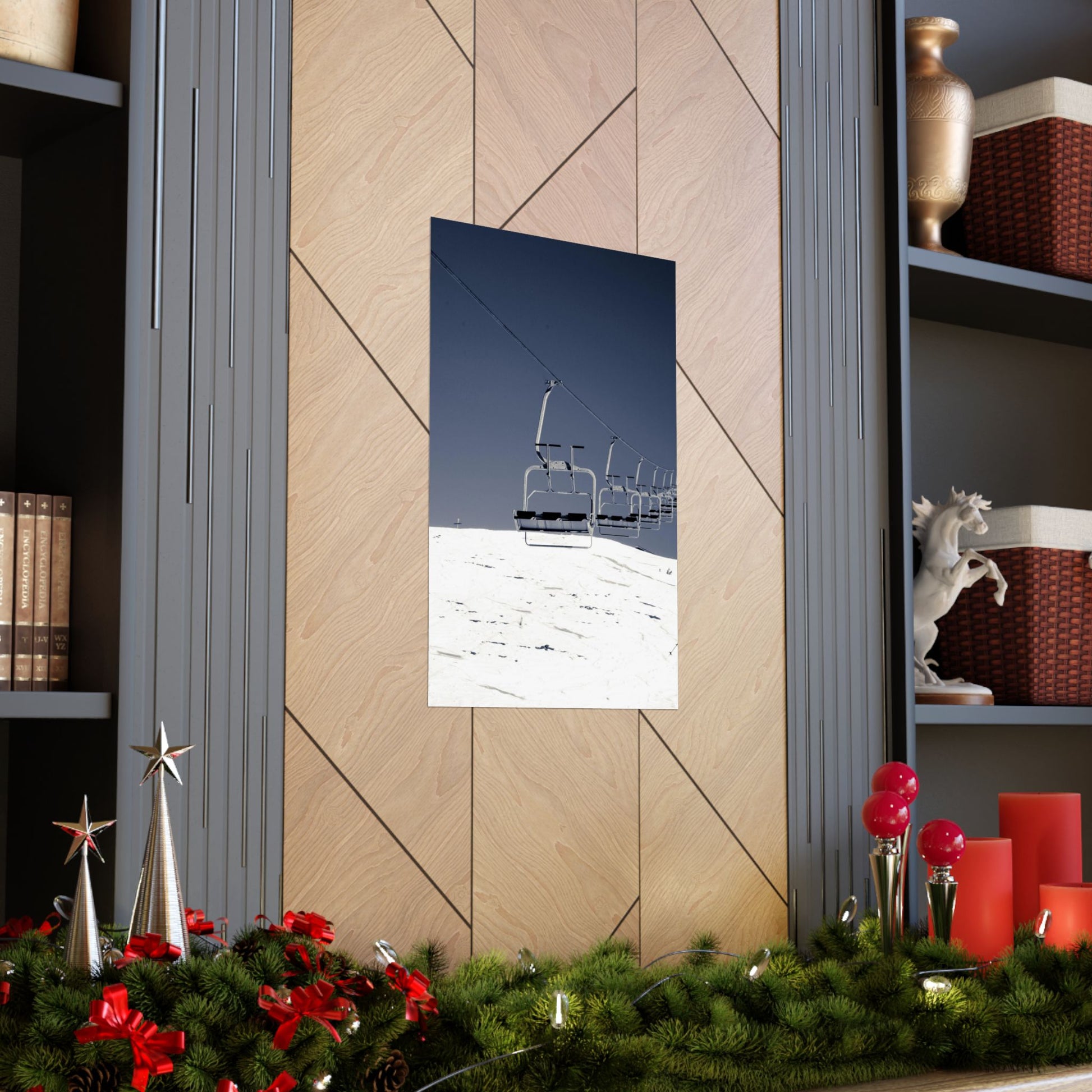 Decorative mirror with a mountain scene on a wall with shelves and Christmas decorations.