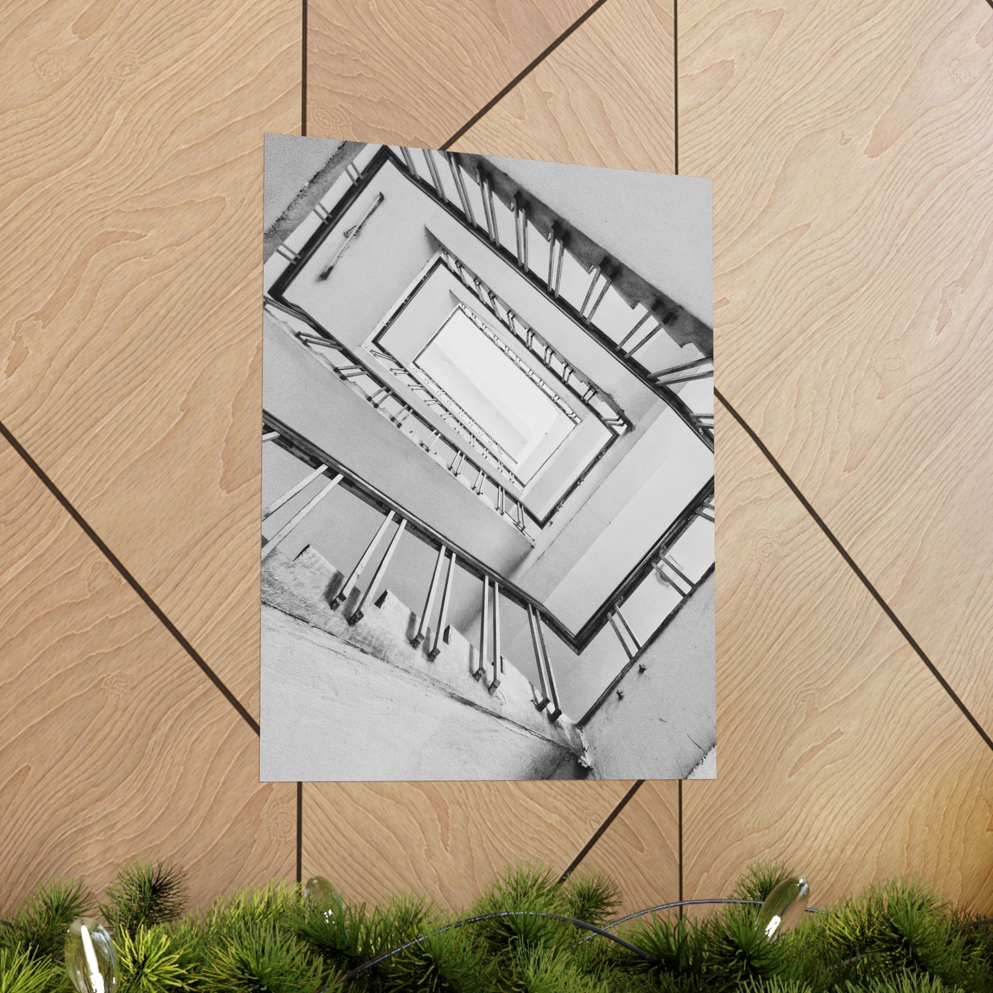 Poster of a staircase on a wooden floor with green plants at the bottom.