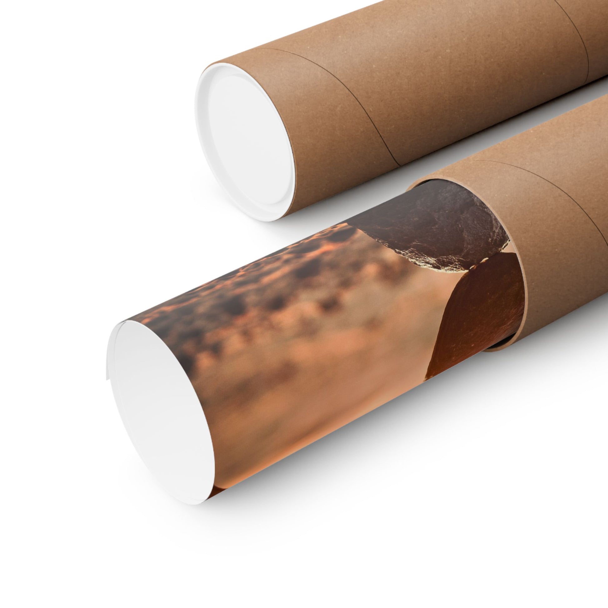 Two cardboard tubes with one featuring a printed landscape design on a white background