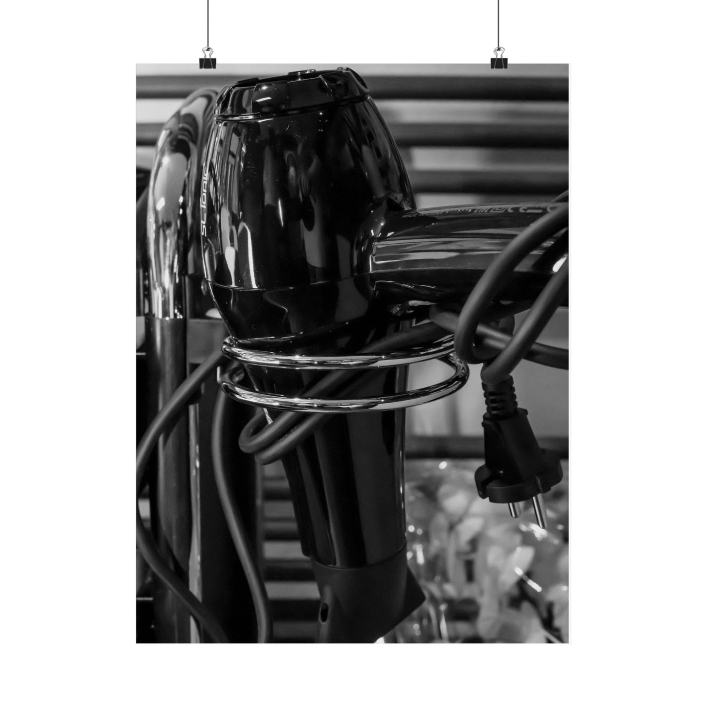Black hair dryer with visible cord on a blurred background