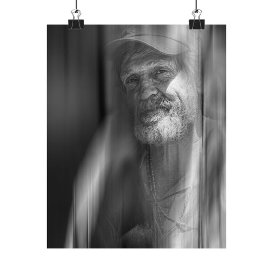 Black and white portrait of a man with a beard and hat, framed by curtains.