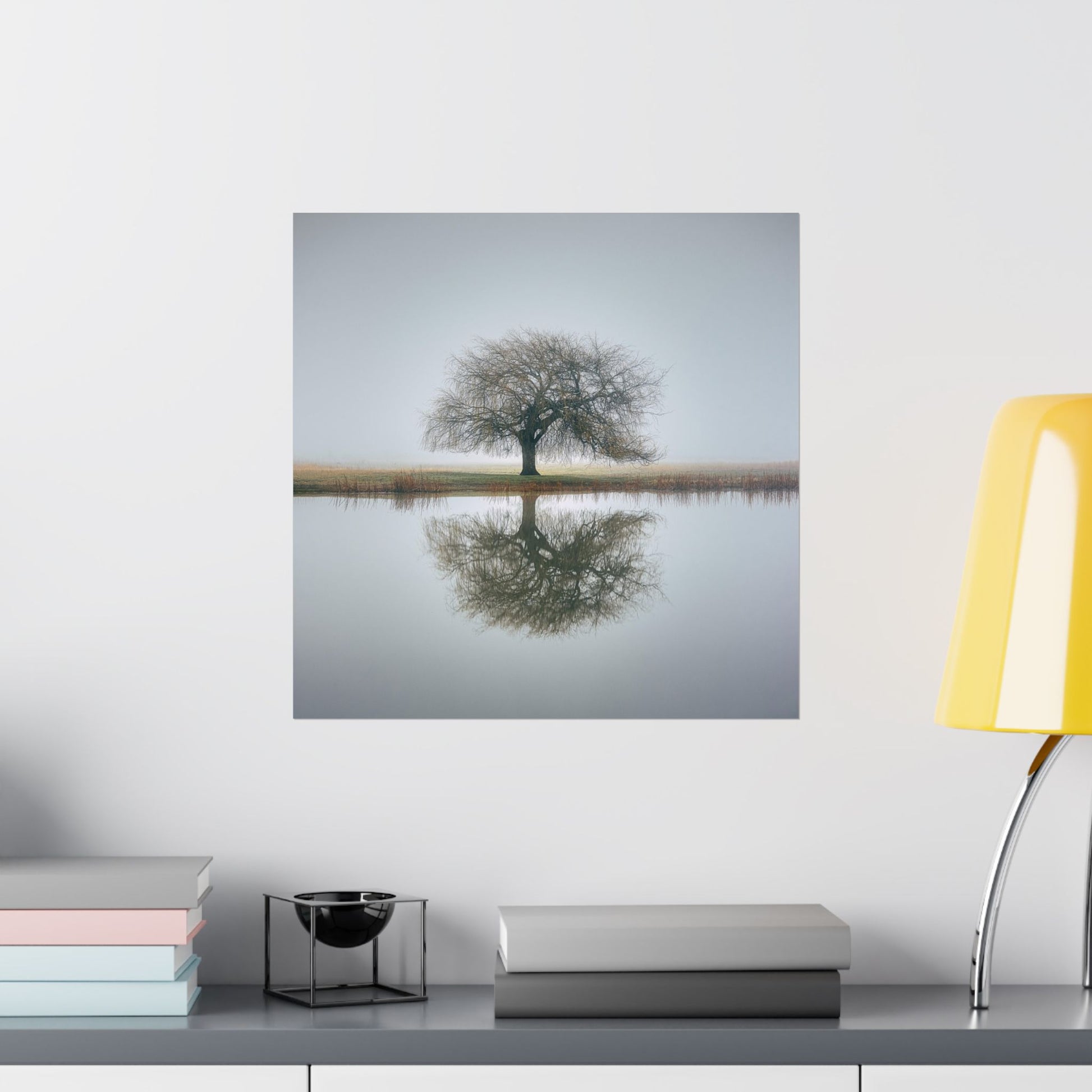 Wall-mounted TV displaying a nature scene with a tree and water, placed on a shelf with decorative items.