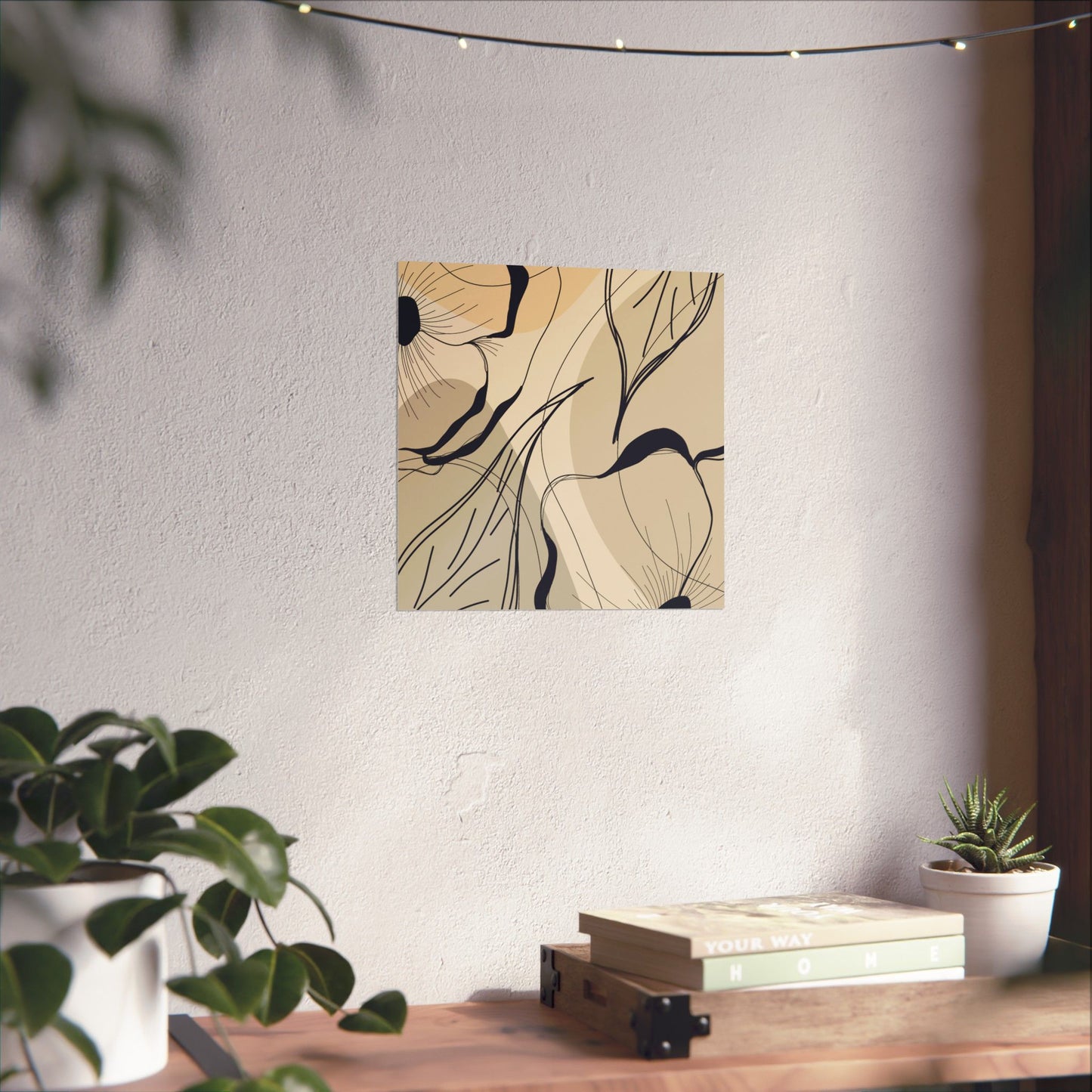 Abstract wall art on a white wall with a wooden table and plants in the foreground