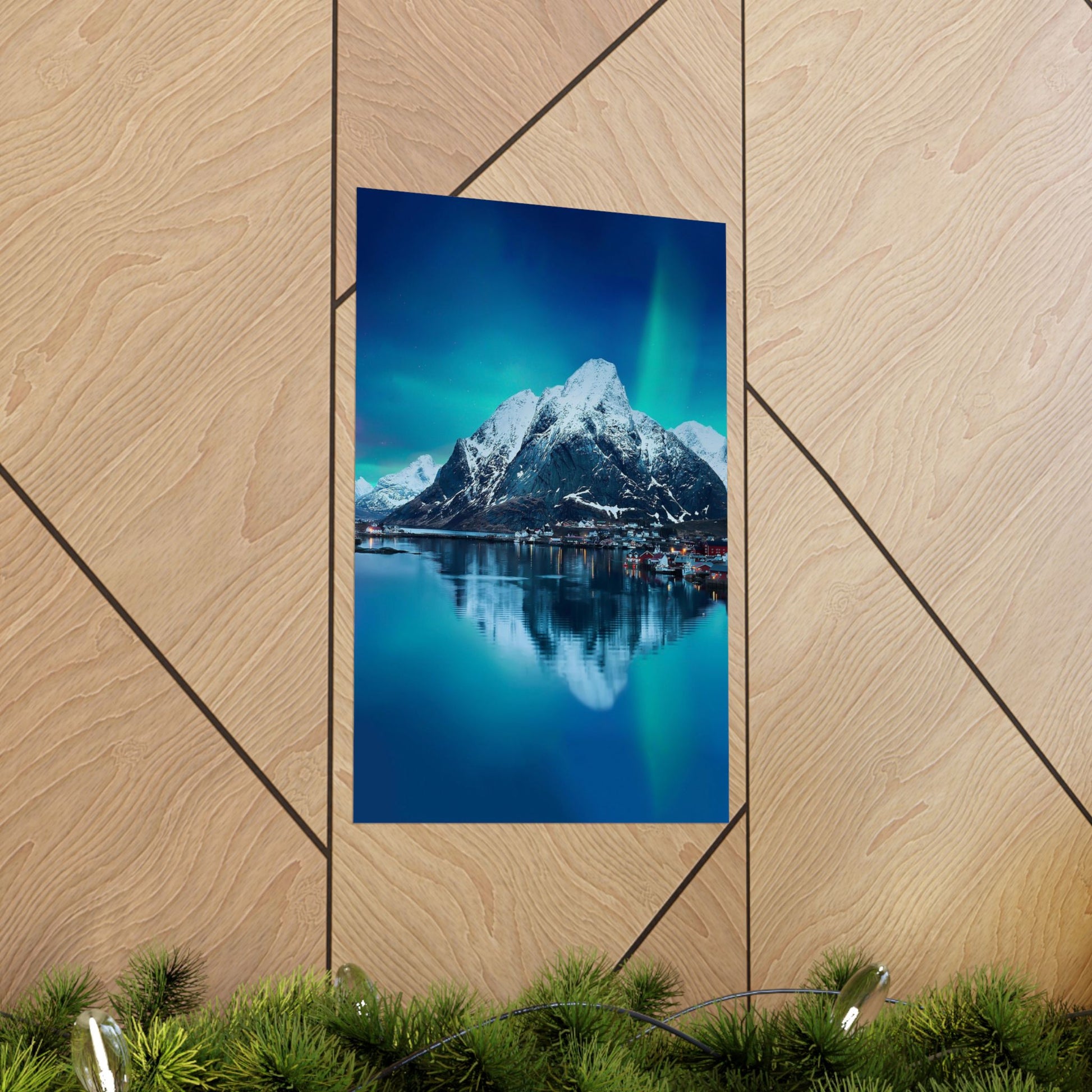 Framed photograph of a mountain landscape with a lake on a wooden wall.