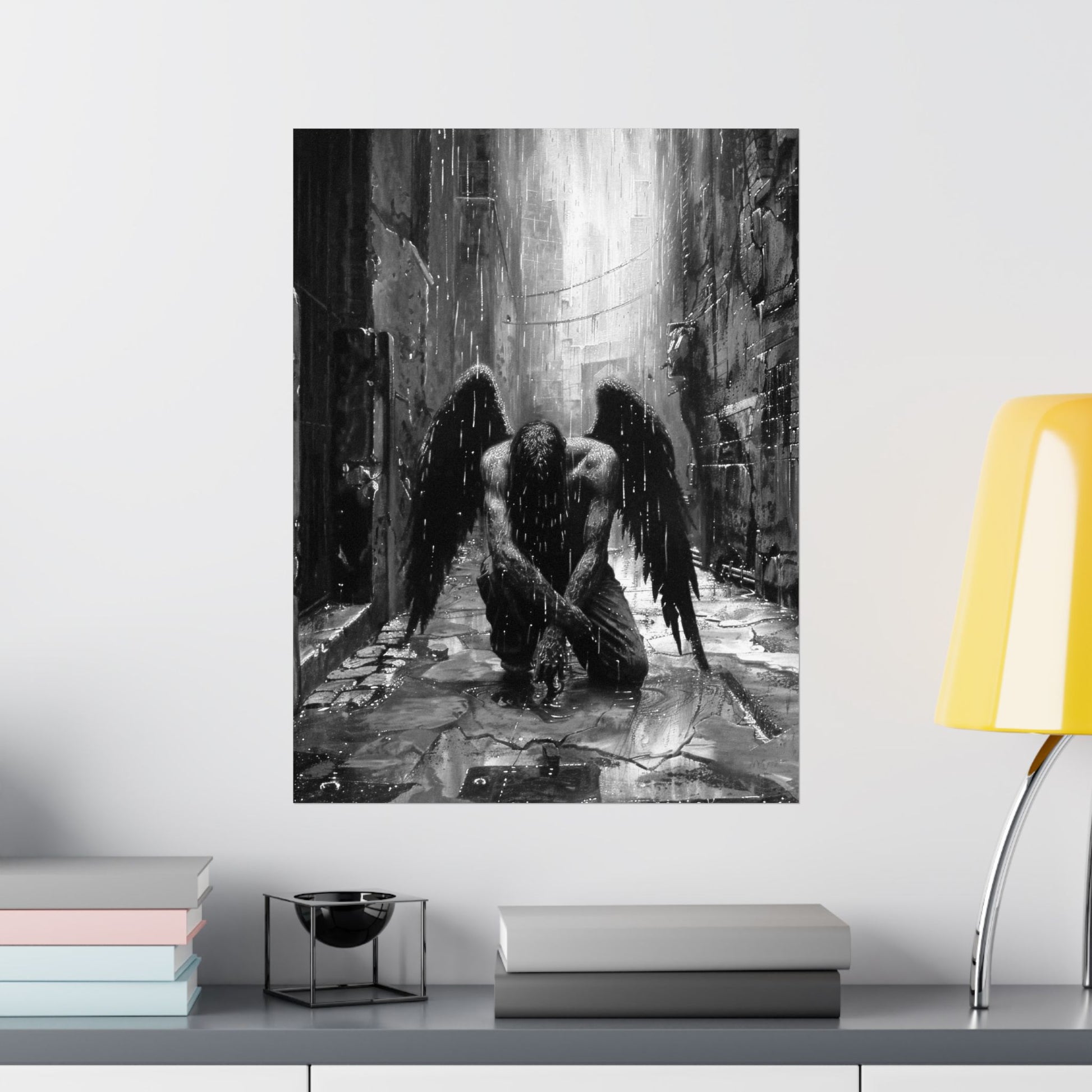 Art print of a dark angel kneeling in a cathedral on a wall above a shelf with books and decor.