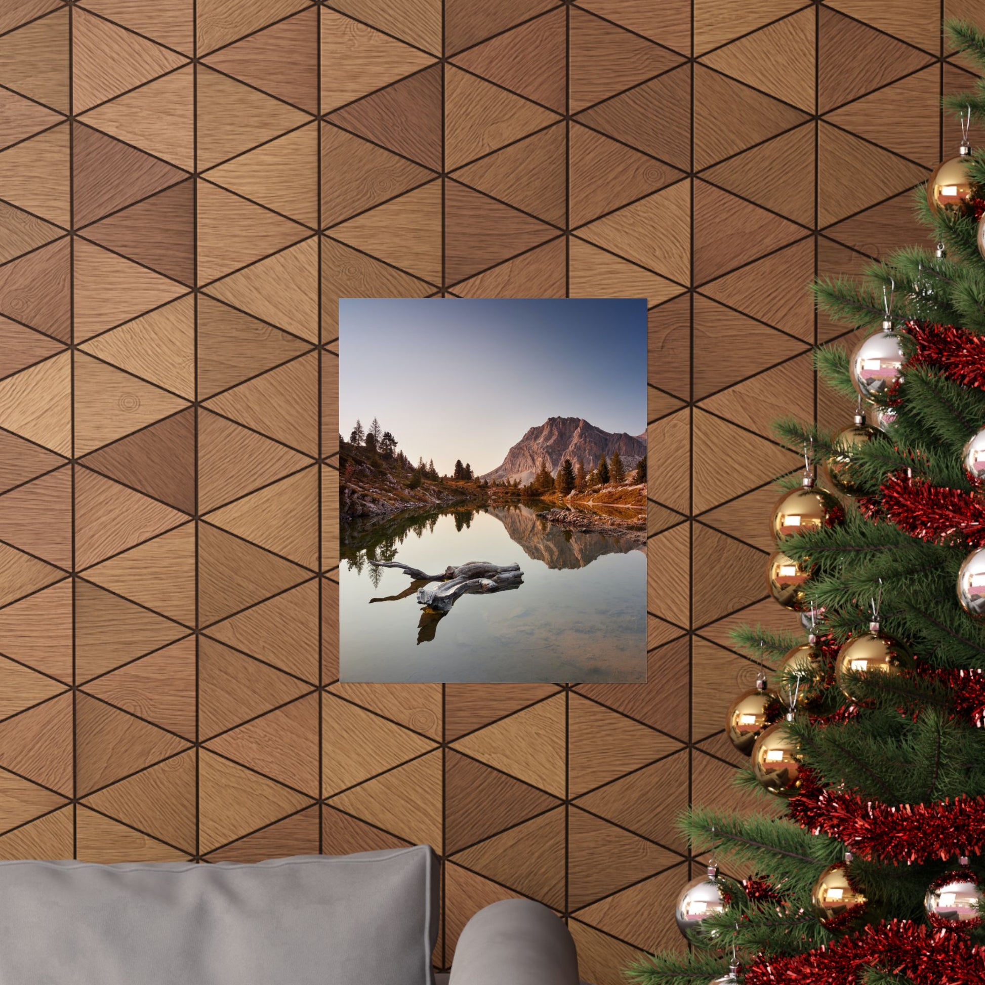 Decorative wall with geometric wood pattern, framed landscape print, and Christmas tree.