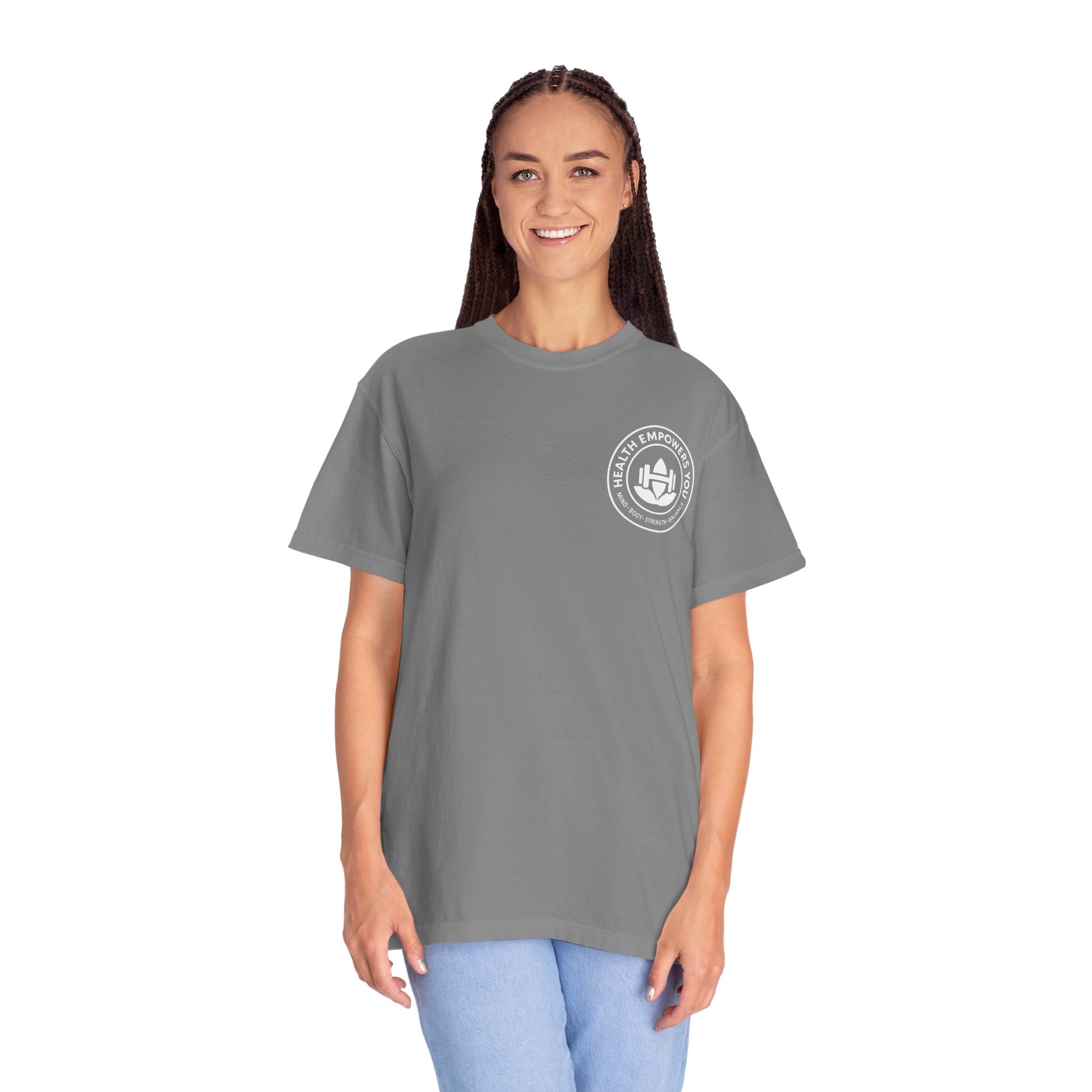 Person wearing a gray t-shirt with a logo on a white background