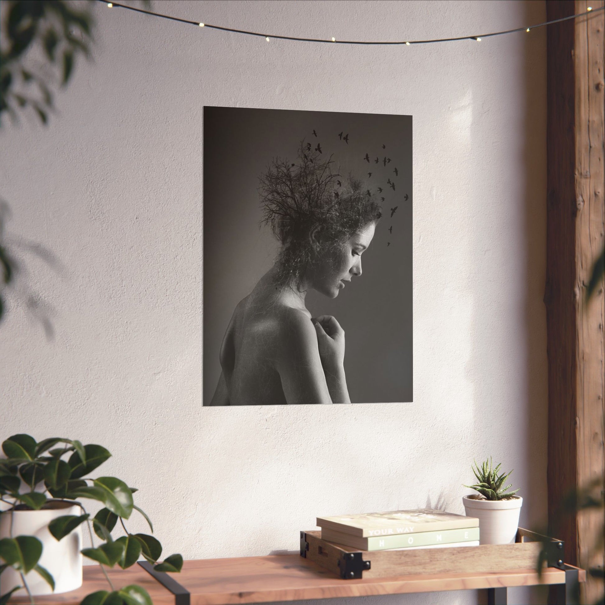 Black and white portrait of a woman with nature elements on a wall above a wooden shelf with books and plants.